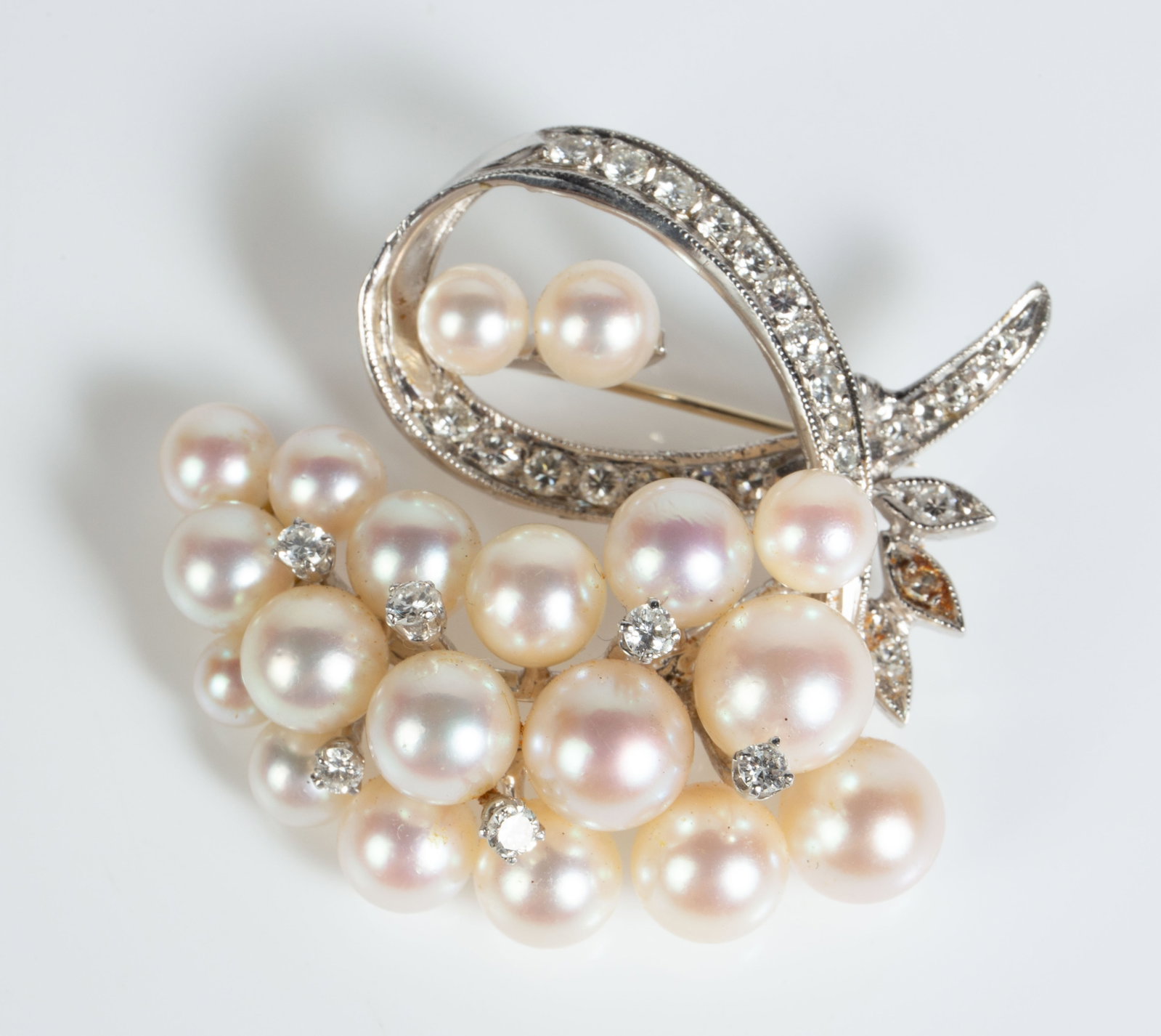 14K White Gold, Pearl, Diamond Brooch.: The brooch appears to be unmarked, but tested appropriately for 14K gold. The piece resembles a grape bunch or an abstract design composed of cultured pearls and small round diamonds. The largest diam
