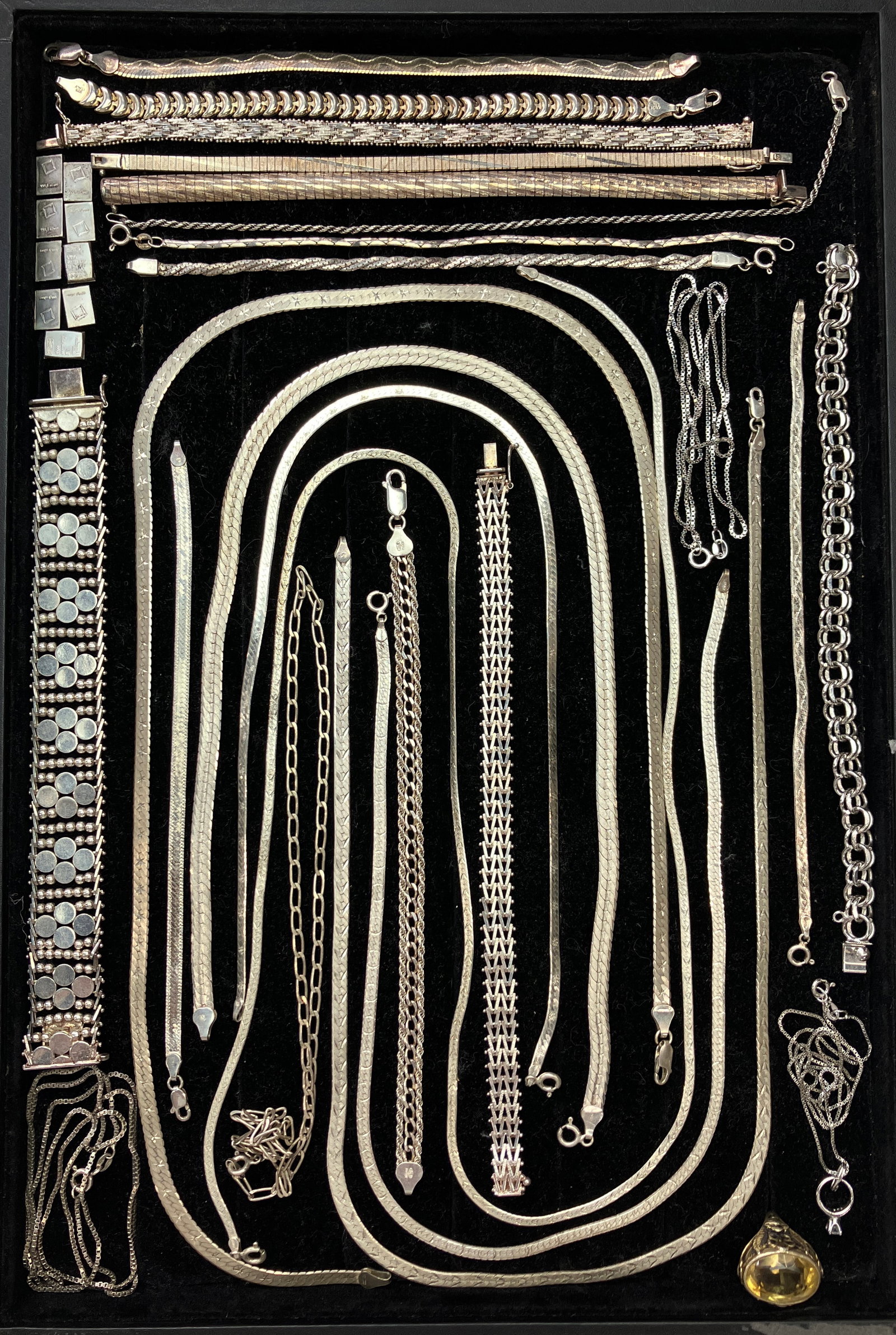 Lot of Sterling Silver Jewelry & 1 Gram Bars.: The lot contains 25 pieces of jewelry and nine 1 gram .999 silver bars. The jewelry includes 14 bracelets, 10 necklaces, and one ring with a light yellow stone, possibly citrine. Besides 925 and Sterl