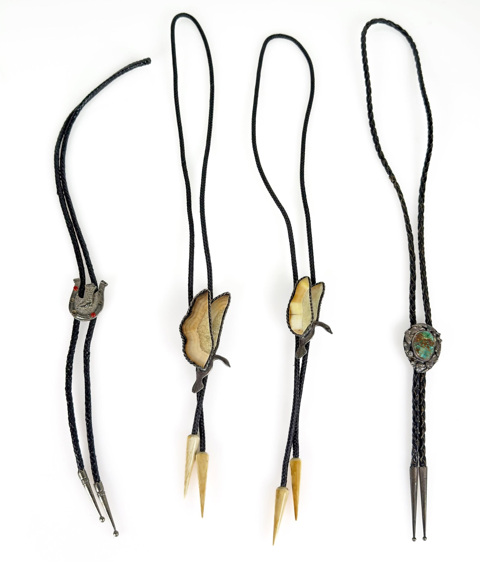 Lot: Mostly Sterling Silver Bolo Ties - Bennett.: The lot contains 4 bolo ties, 3 of them sterling. The two swan bird pieces are stamped Sterling Houston, and the largest one also has a scratched code that reads 7792 Ori-Ak 104, along with a patent n