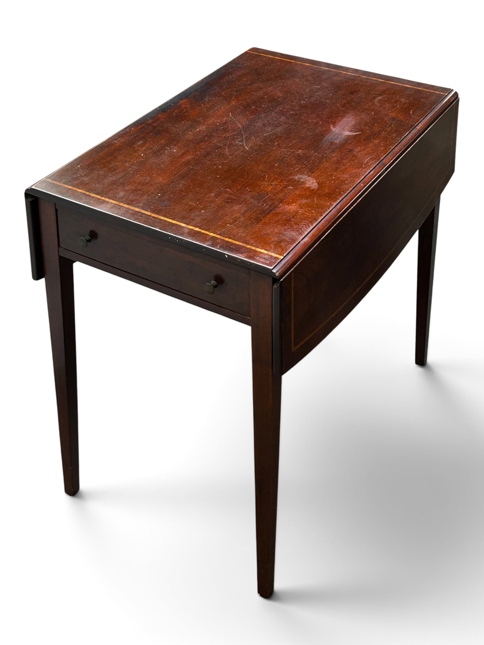 Antique Mahogany Dropleaf Pembroke Table.: The table has 4 tapered legs, one drawer with two brass pulls, two drop leaves, and an inlaid light wood border decoration on top. It measures 26 1/2" tall, 19" wide, and 29" deep (without extending a