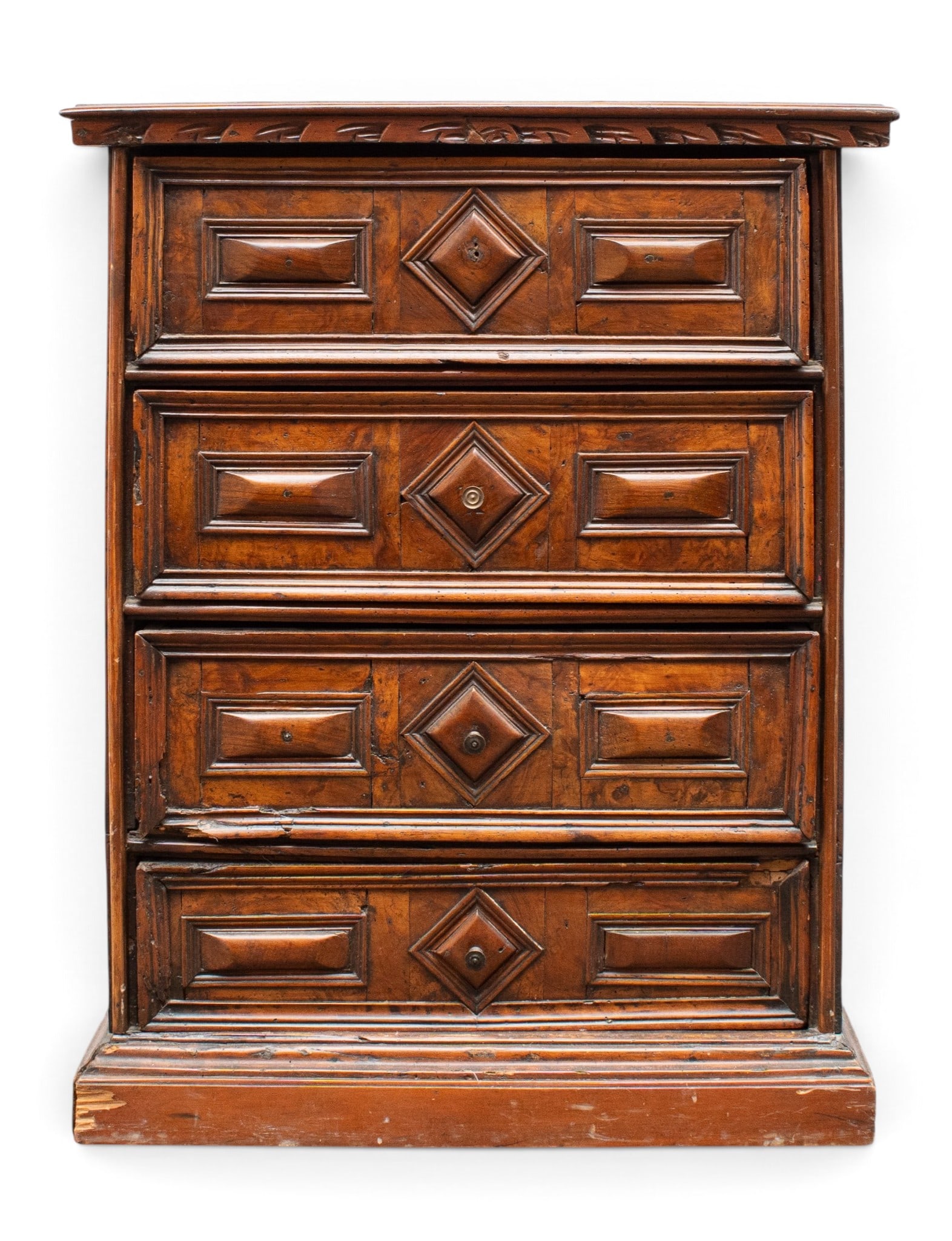 Italian Baroque Carved Chest of Drawers.: The drawered chest has a slightly angled front, being that the bottom is deeper than the top. It has 4 drawers with geometric carvings, and a carved front apron under the top. It measures 34 3/4"