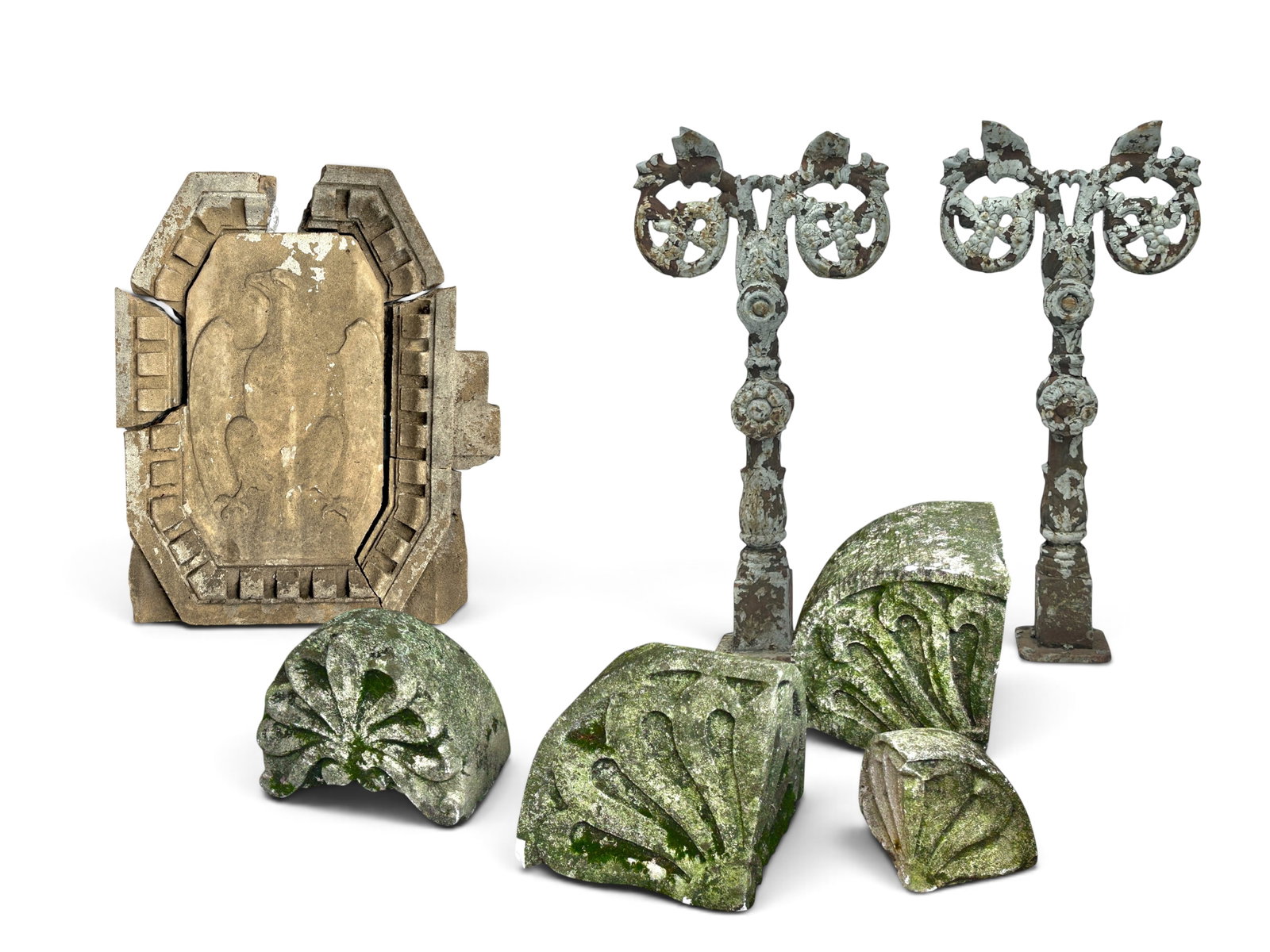Lot Architectural Salvage Items, Iron Post Bracket: The lot contains 7 items. There is a pair of ornate cast iron post or newel brackets, 4 pieces of arched carved stone, and one decorative eagle medallion carving with a carved border, which is broken