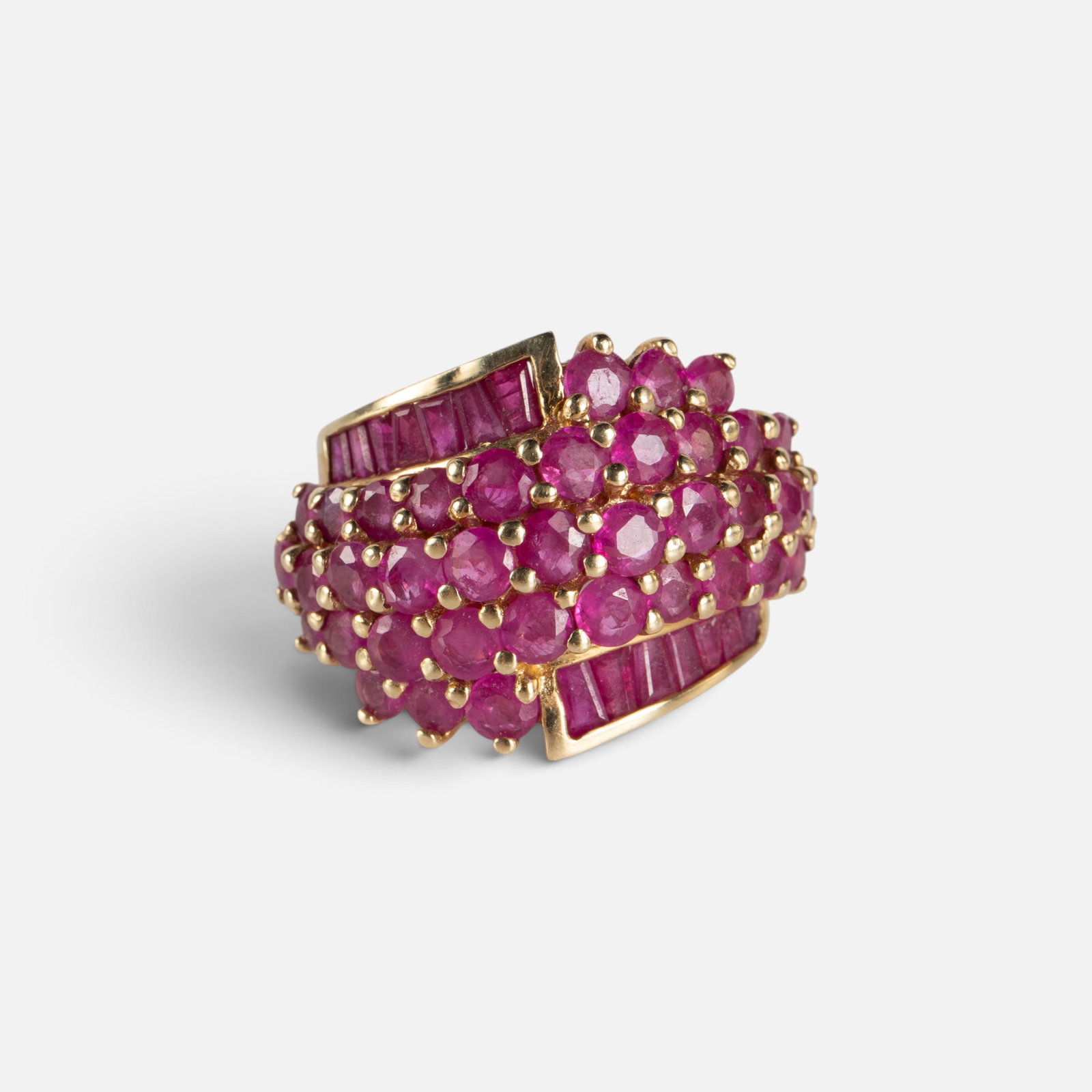 10K Yellow Gold Ruby Cluster Ring.: The ring is marked 10K / THL inside the band. It features a large surface area of round and baguette cut rubies. The cluster surface measures 1 1/8" x 5/8". The largest round rubies measure 3mm in