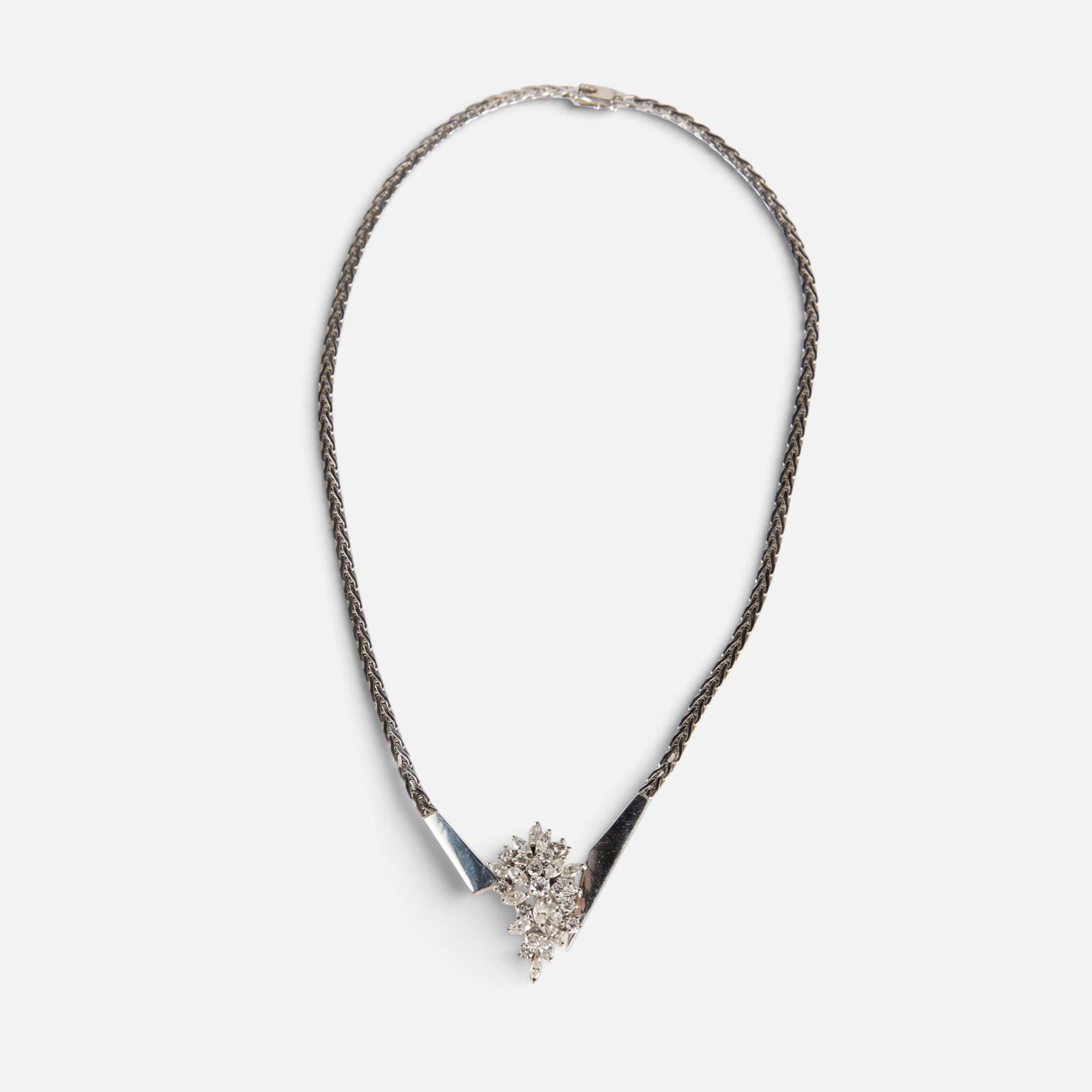 14K Gold Asymmetrical Diamond Cluster Necklace.: The white gold necklace is marked 14K on the clasp. It features an asymmetrical center design, with a large marquis and round cut diamond cluster. The cluster measures 1 3/16" x 3/4". The complete
