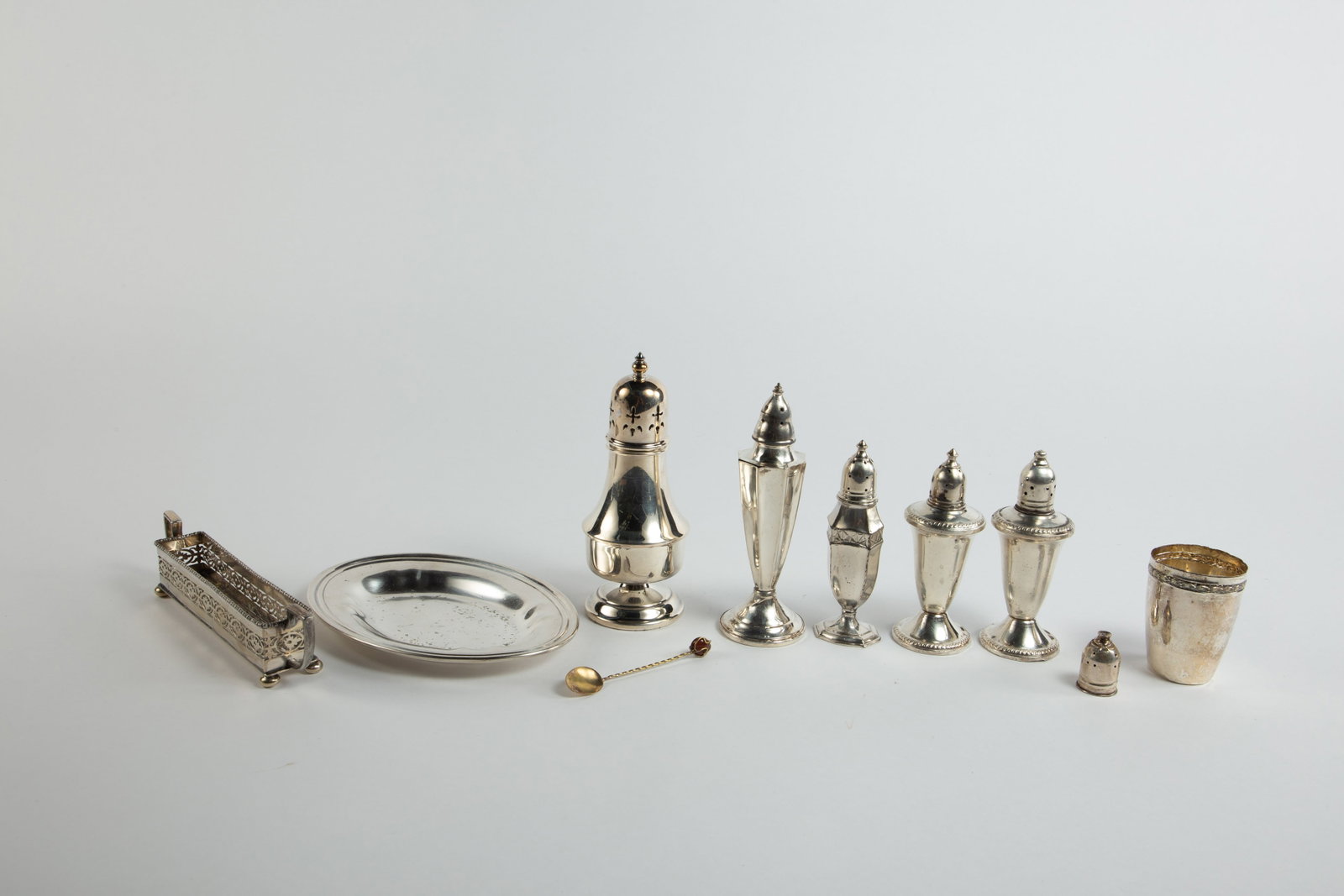 Lot of Silver and Silverplate Table Articles.: This lot includes a pair of weighted sterling Duchin Creation salt shakers (plus one extra shaker top), an N.S. Co. weighted sterling salt shaker, a Wilhelm Binder .800 silver cup, and several