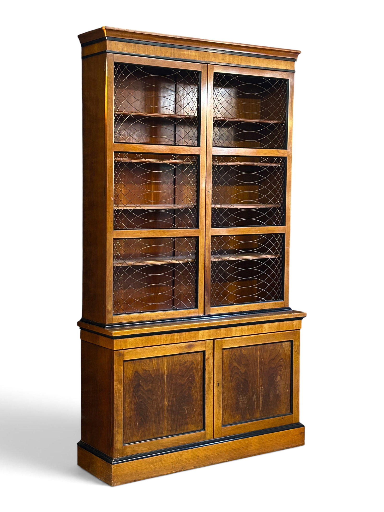 Baker 2-Piece China Display Cabinet w/ Brass Wire.: The vintage piece has an upper section with two doors with open brass wire decorations on the outside. Inside, it has 4 shelves, and a lower section with two solid doors with one shelf inside. The