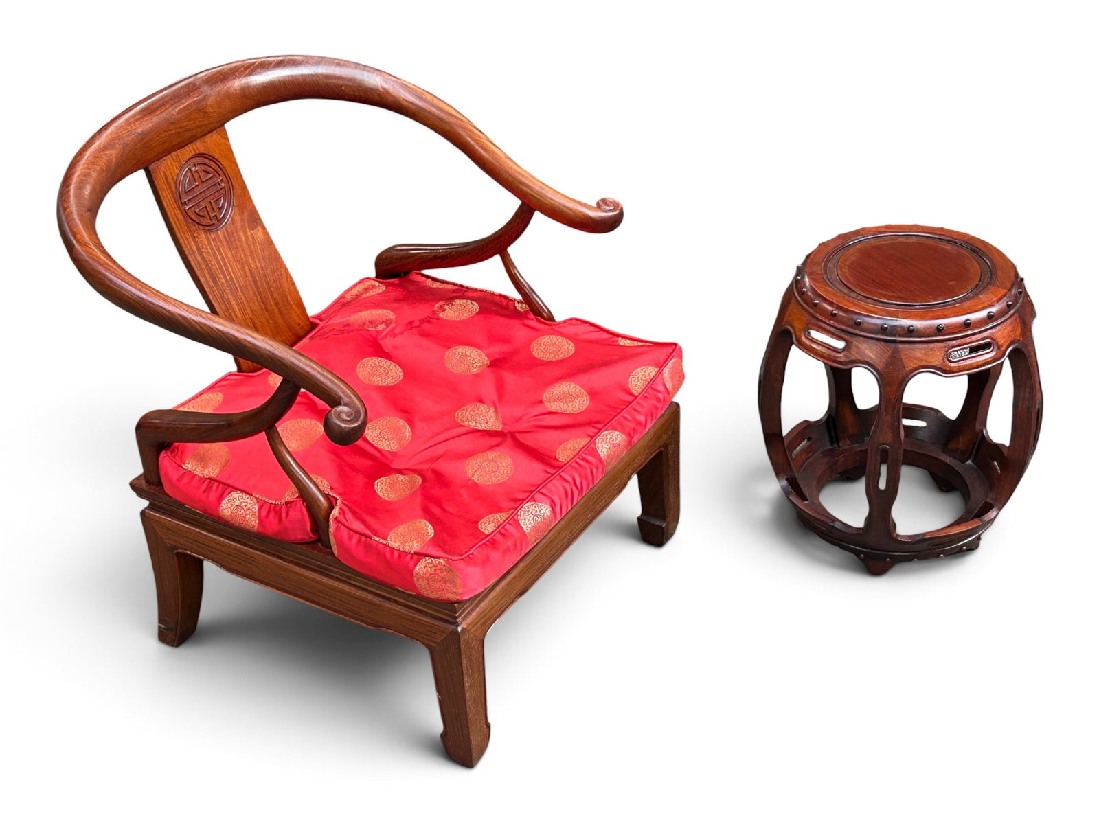 Lot: Chinese Ming Style Carved Armchair & Stool.: The traditional Ming style armchair has a horseshoe back with scrolled arms, and a removable red silk upholstered seat cushion. The drum or barrel style garden stool has studded details and large cuto