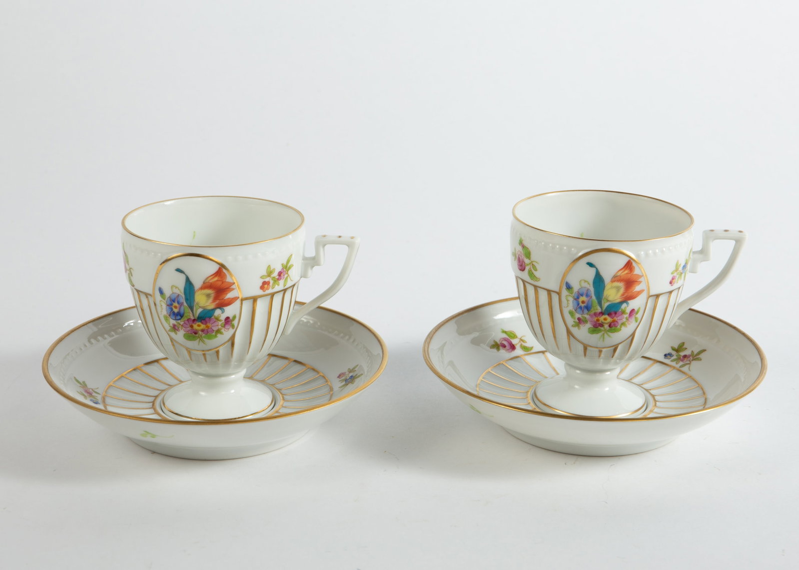 Pair of Herend Footed Floral Teacups w/ Saucers.: They look to be in nice cosmetic condition. Each teacups measures 3 5/8" x 2 7/8" x 3". Each saucer measures 5 3/8" x 5 38" x 1 1/8". In-house shipping is available. To receive the best shipping rate