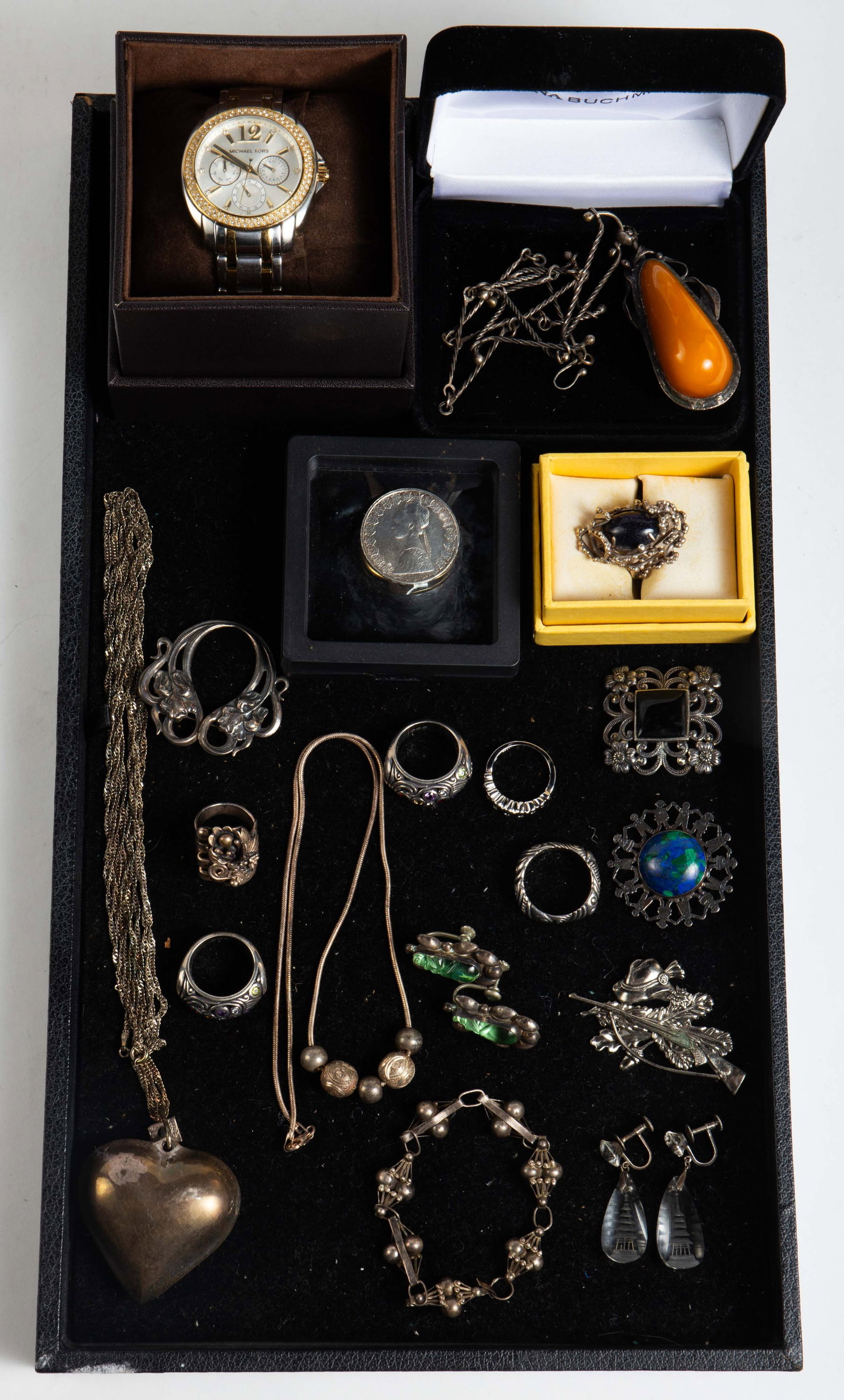 Lot Mostly Sterling Silver Jewelry - Amber, Native: The lot contains 18 items. There are 3 necklaces, 4 brooches, 2 pair of earrings, 6 rings, a bracelet, a Michael Kors 5693 watch, and an Italian 500 Lire 0.835 silver coin with a scarf clip glued to t