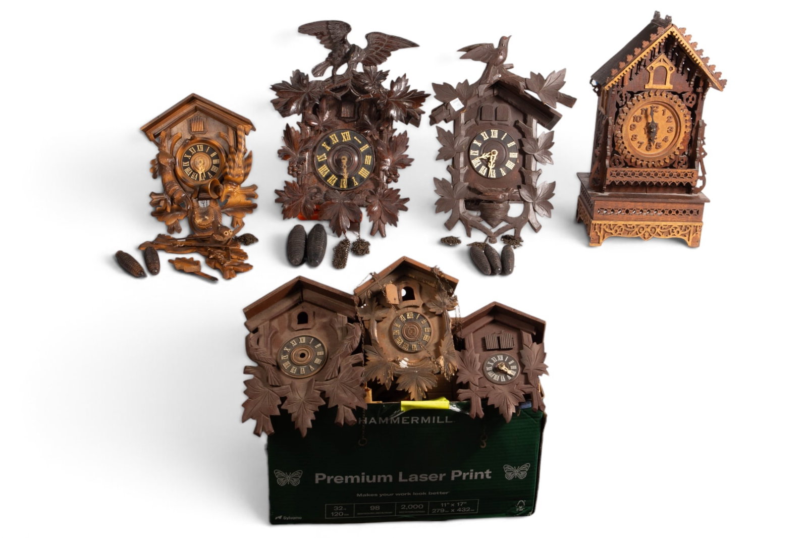 Lot of Carved Black Forest & Other Clocks.: The lot contains 7 clocks in various condition. All of them are untested. The cuckoo clocks have intricate carvings. The two dark wood pieces feature birds and foliage, and the light wood piece,