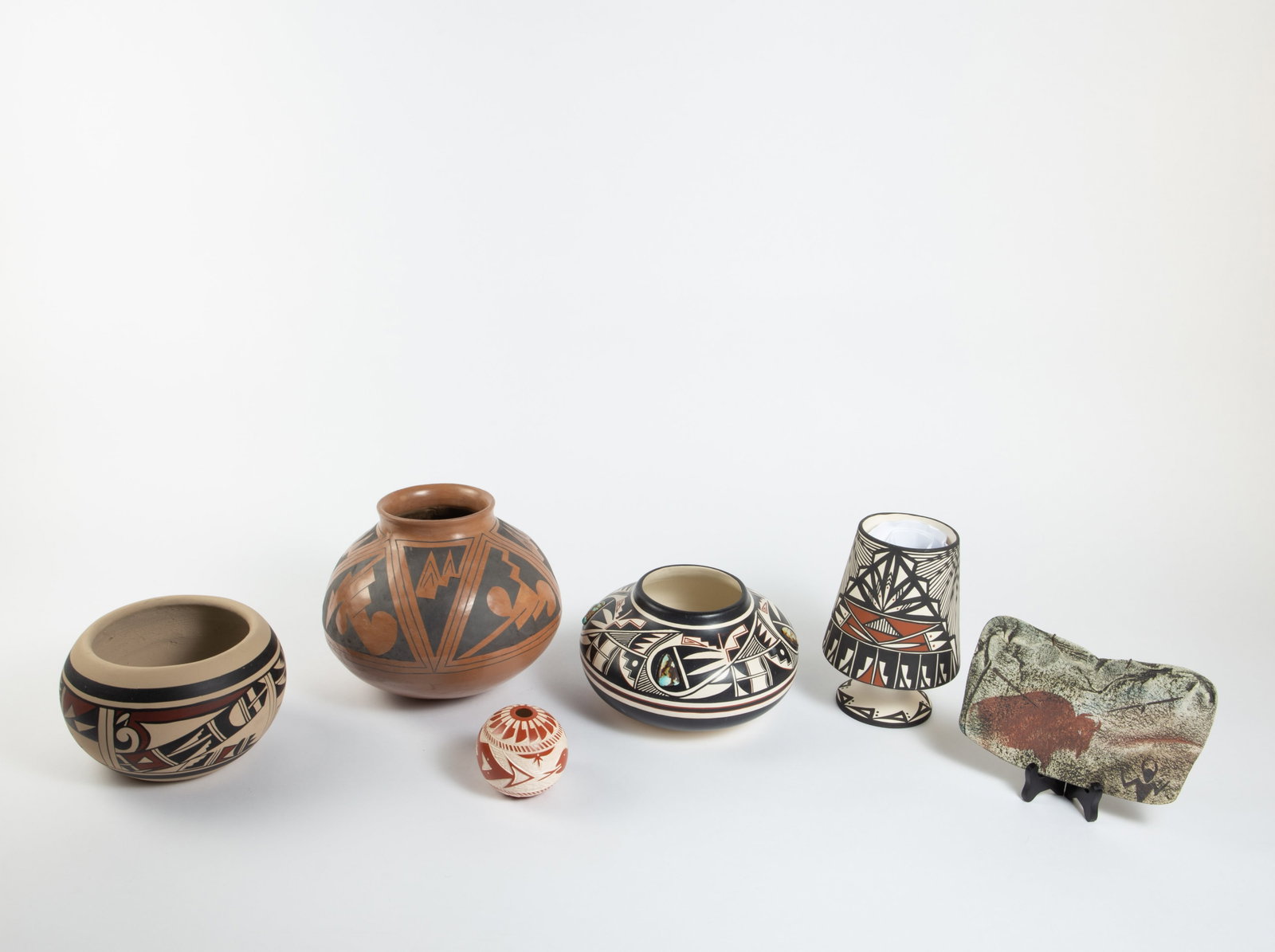 Lot of Mostly American Indian Pottery- Vases, etc.: This lot includes a Laguna seed pot, a Robert Reid painted vase with turquoise, a large Mata Ortiz pottery vase, a D. Trujillo Acoma pottery vase, and more. Overall, the lot looks to be in good condit