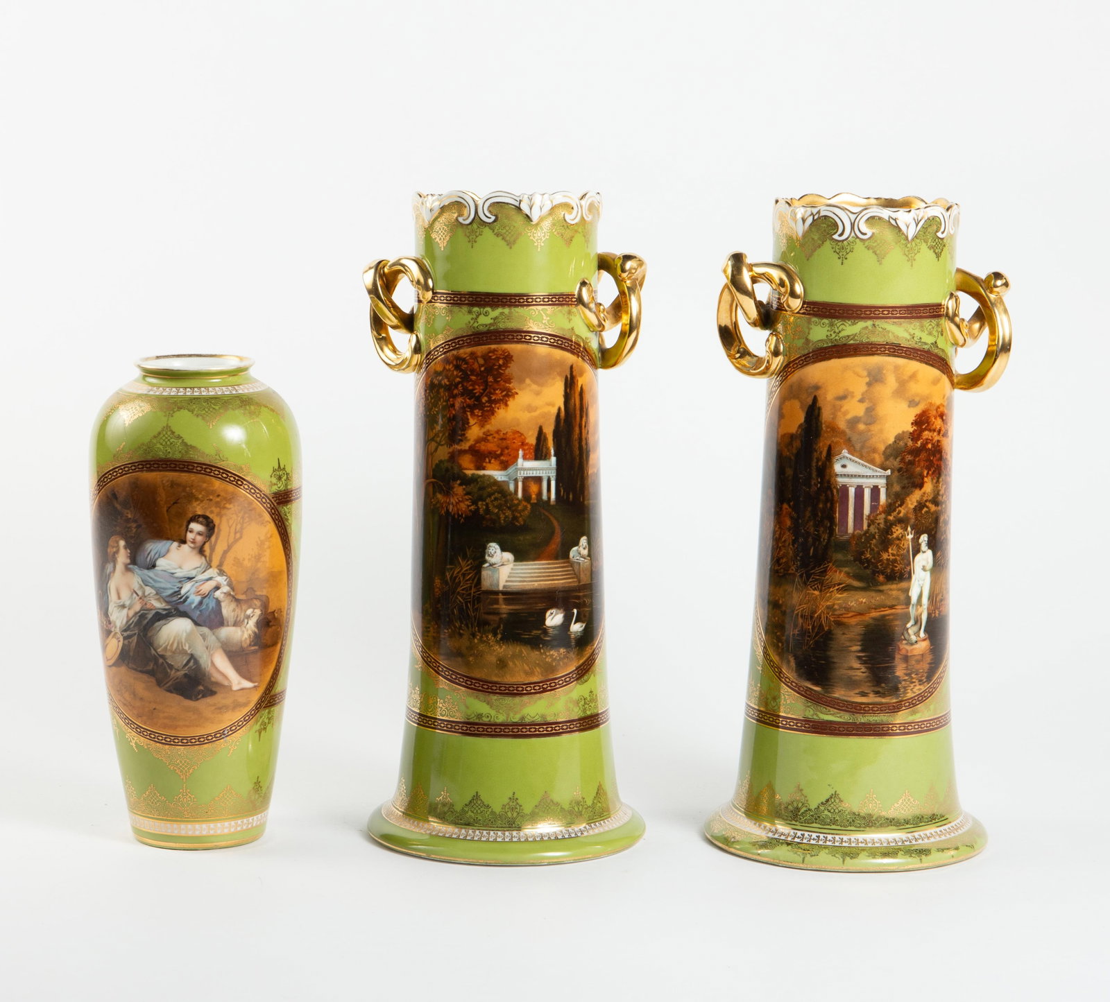 Royal Vienna Style Green Porcelain Vase Set.: This lot consists of a taller pair of vases with gilded handles, and a shorter vase without handles. Overall, the lot looks to be in good cosmetic condition. The two taller vases measure 5 7/8" x 5 7/