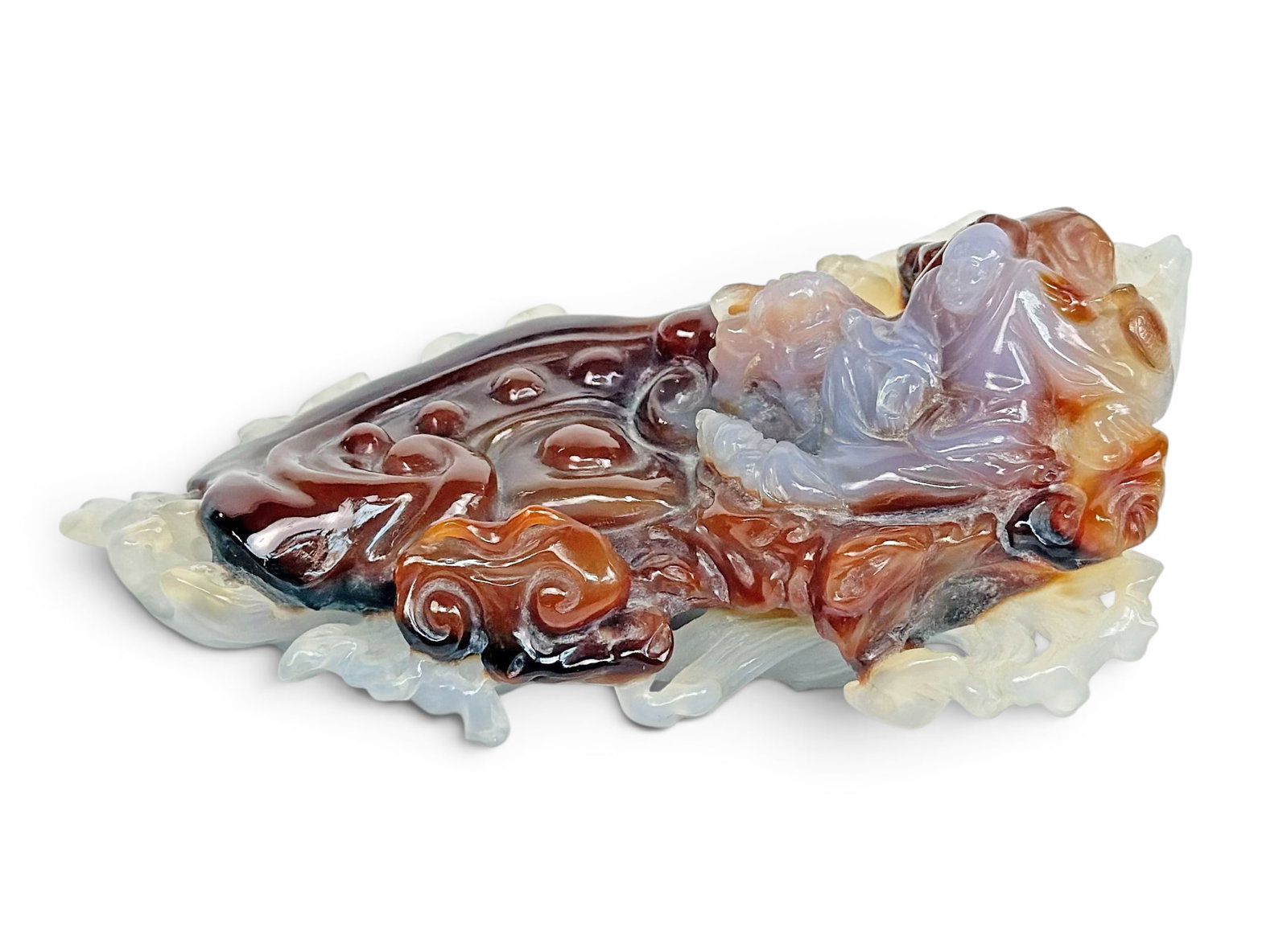 20th Cent. Chinese Carved Agate Buddha Figure.: The intricate piece appears to depict a seated Buddha with a foo dog by its side on a fluid base, which possibly depicts water. The piece measures 2 3/4" x 6 5/8" x 3 1/2". The piece is in overall ver