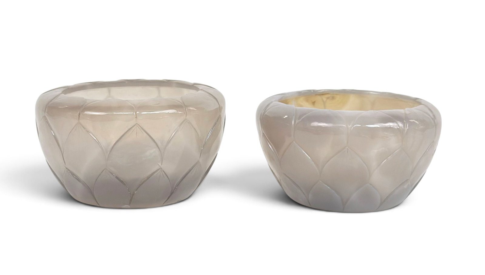 Pair of 20th C. Chinese Agate Lotus Flower Bowls.: The carved stone bowls are both signed on the undersides. They measure 2 5/8" tall and 5" in diameter. The bowls have some flea bite chips or indentations on the interior of the bottom bases, and the