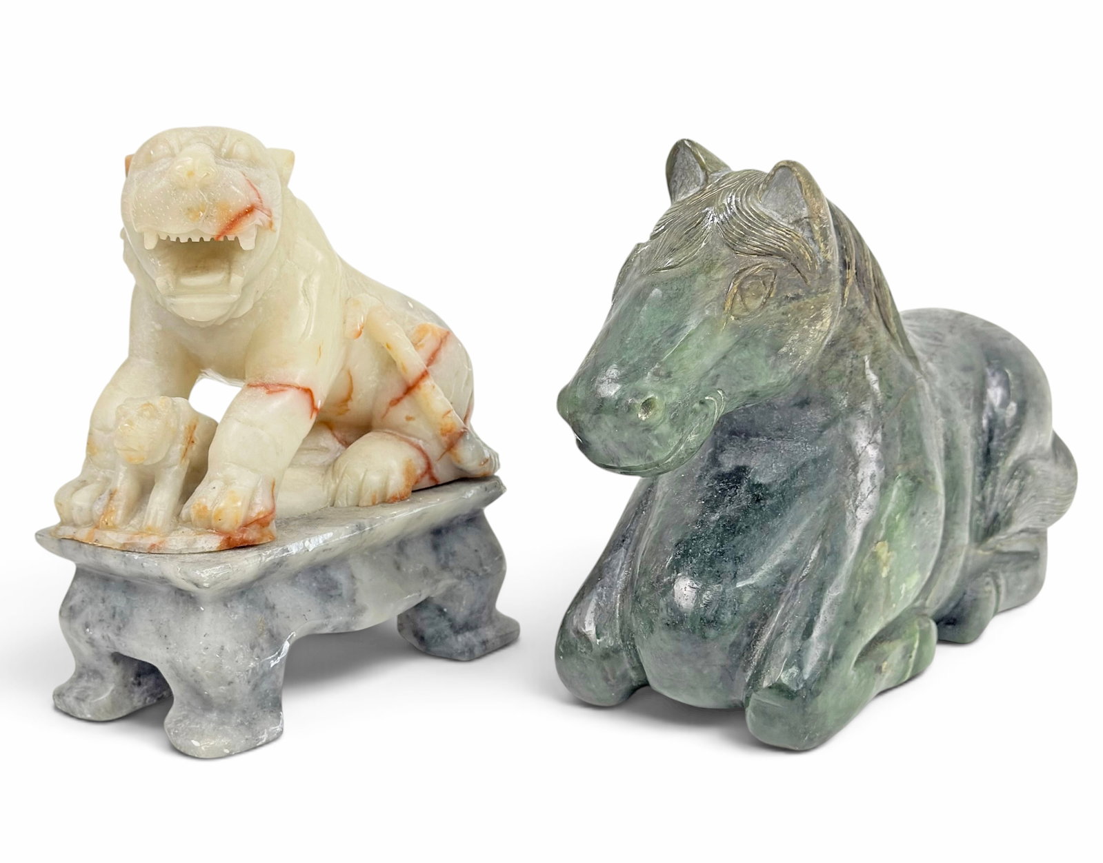 2 Chinese Stone Sculptures - Tiger & Jade Horse.: The lot contains 2 carved sculptures. There is a heavy green jade sitting horse, and a soapstone tiger and cub on a base. The horse measures 7 5/8" tall, 11 1/4" wide, and 4" deep. The soapstone piece