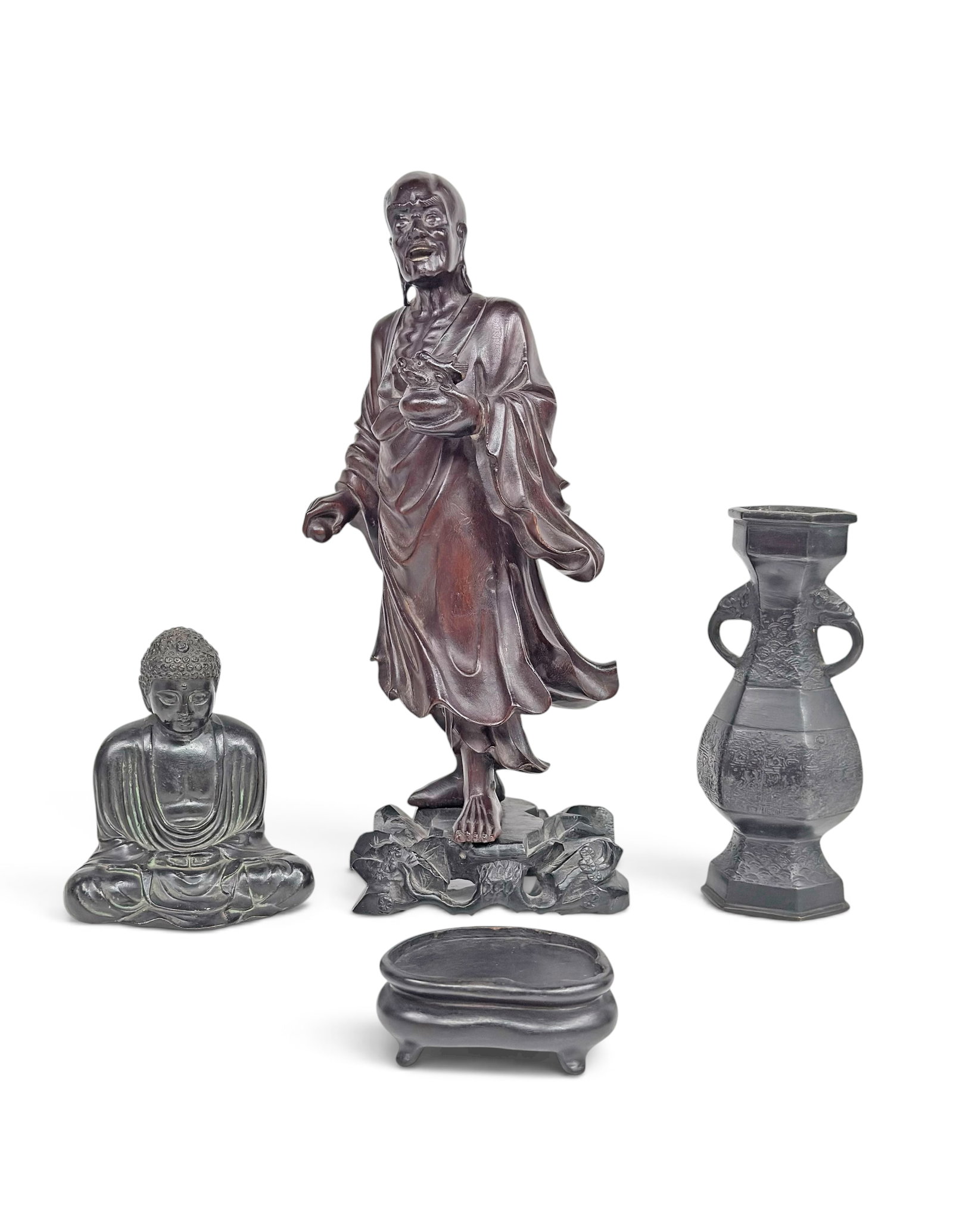 4 Japanese Items - Carved Wood & Cast Metal.: The lot contains 3 items. There is a carved wood Luohan figure, a cast bronze urn style vase, a cast metal Buddha, and a carved wooden stand. The vase has a stamped signature on the underside. The lar