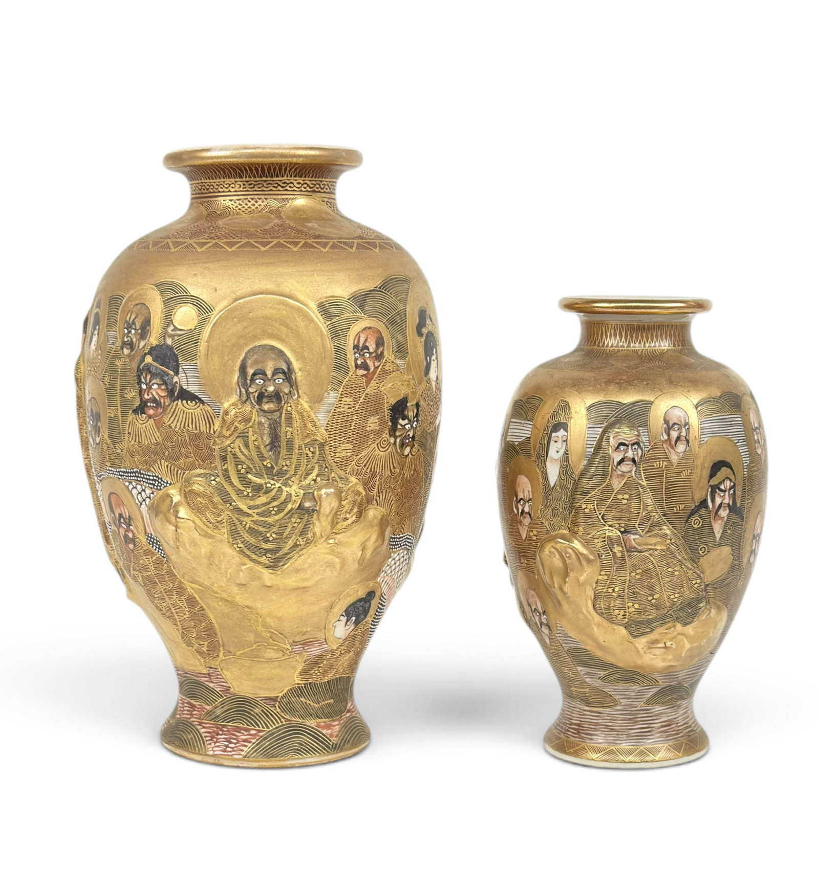 2 Meiji Period Satsuma Vases w Relief Figures, Sgd: The lot consists of two similar vases which feature many handpainted figures, including 2 of them in relief. The vases are signed Hoduda on the undersides. The smallest measures 7 1/4" tall, and the l