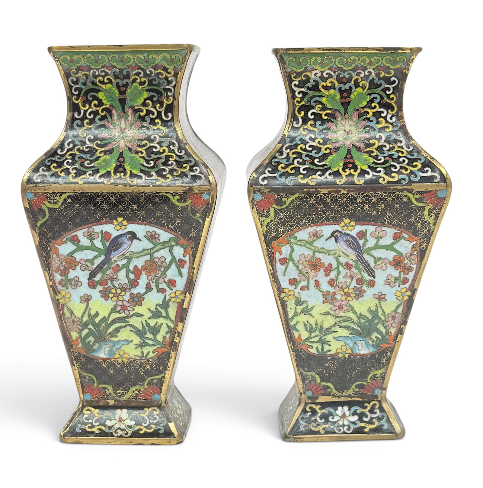 Pair of 20th C. Chinese Cloisonne Enamel Vases.: The vases feature depictions of birds and branches on the four sides, and ornate decorations with gilt details throughout. They measure 9 1/2" x 4 3/8" x 4 3/8". There is some gilt discoloration, and 