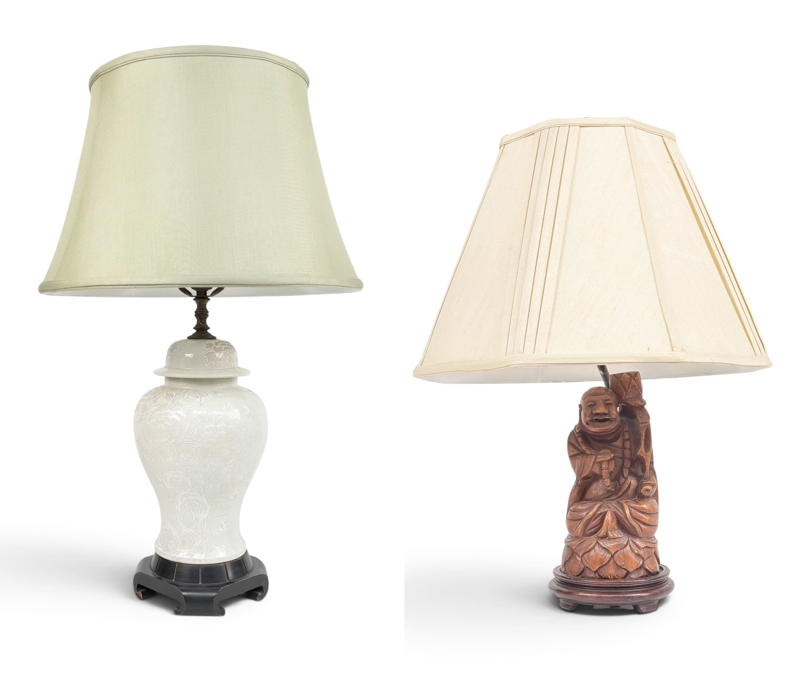 Lot of 2 Vintage Asian Lamps, One w/ Carved Buddha: The lot includes a white porcelain urn-type lamp with floral designs, and a lamp with a carved wood buddha. The former lamp has some wear on its wooden base. The buddha lamp looks to be in good overal