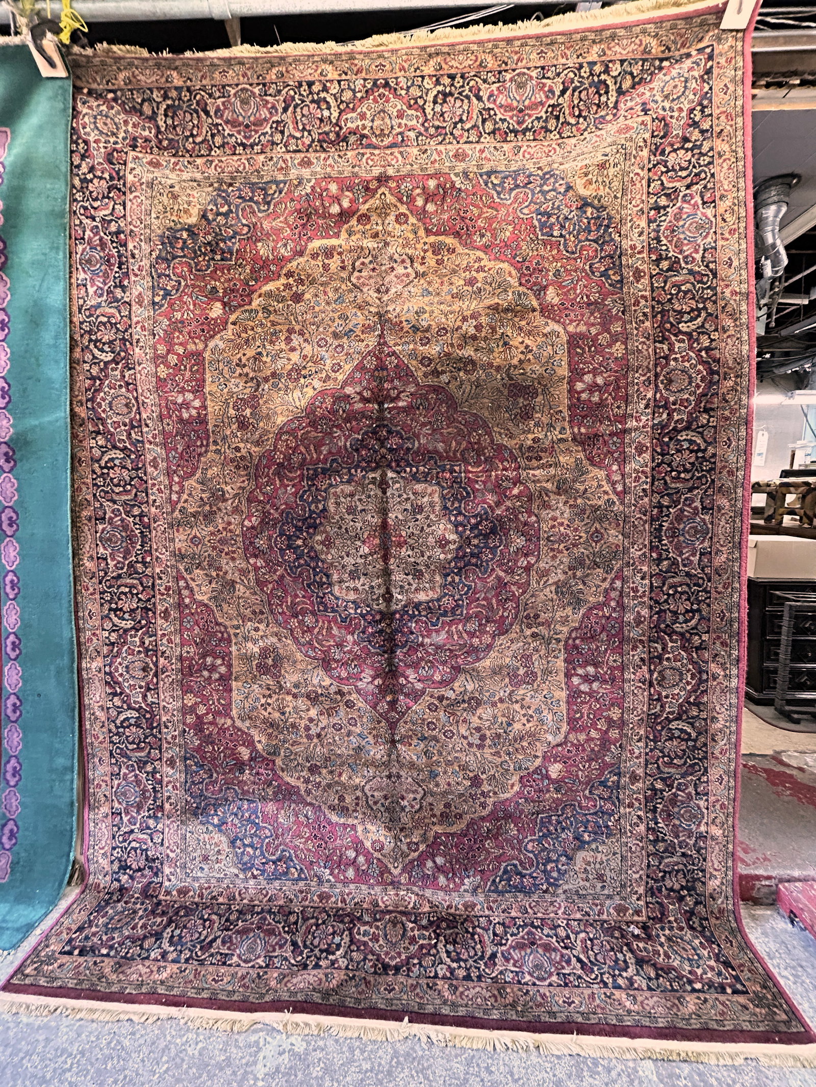 8' 8" x 12' 1" Limited Edition Karastan Rug.: The rug is from "The Legends" series. It is the Antique Kirman pattern, numbered 290 of 300. It looks to be in good overall condition. In-house shipping is available. To receive the best shipping rate