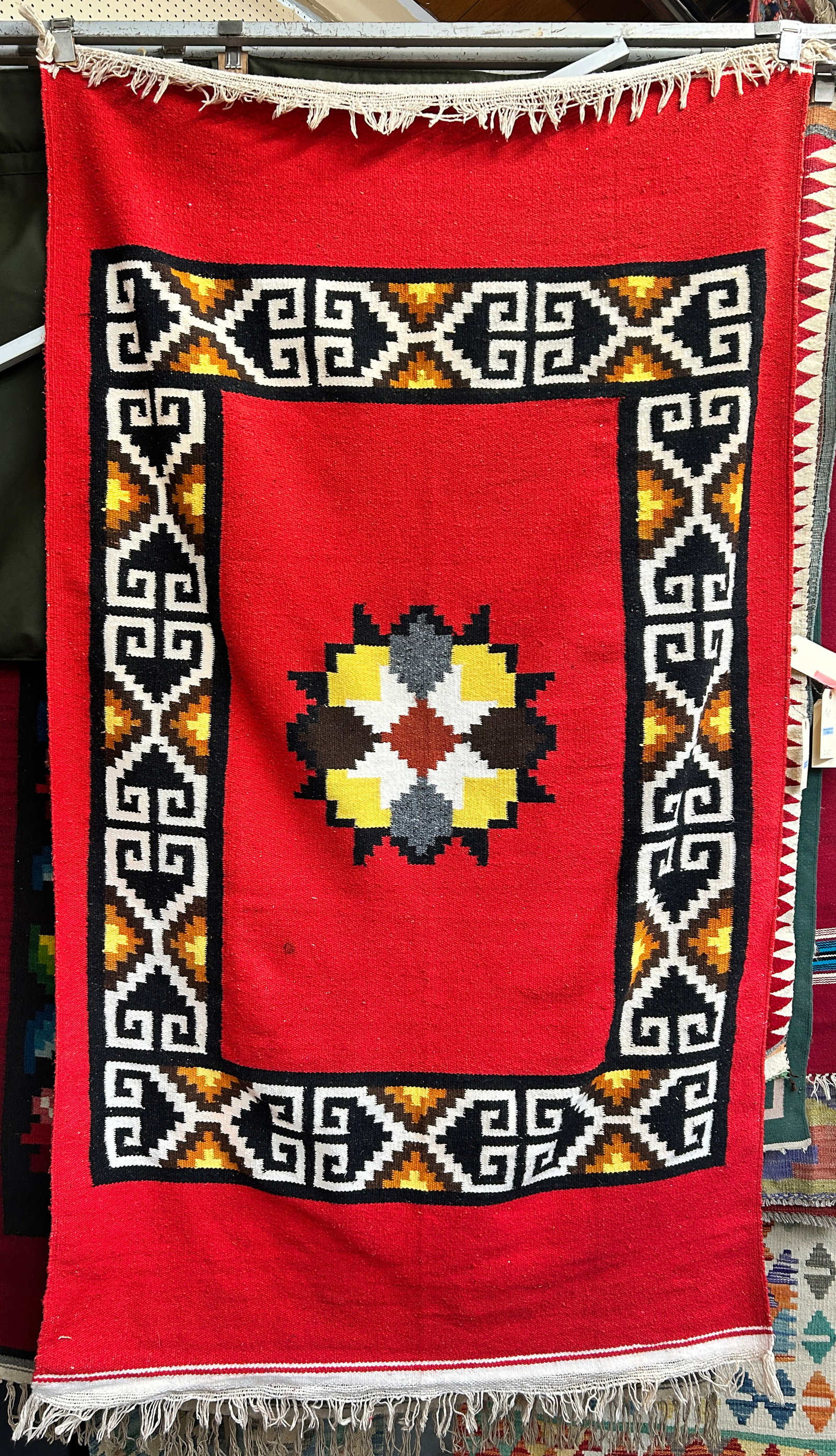 4' 3" x 7' Southwest Style Rug.w/ Red Field.: The rug looks to be in good overall condition. In-house shipping is available. To receive the best shipping rate on this item, please check the "Self Arranged" button at checkout. Our in-house shippin