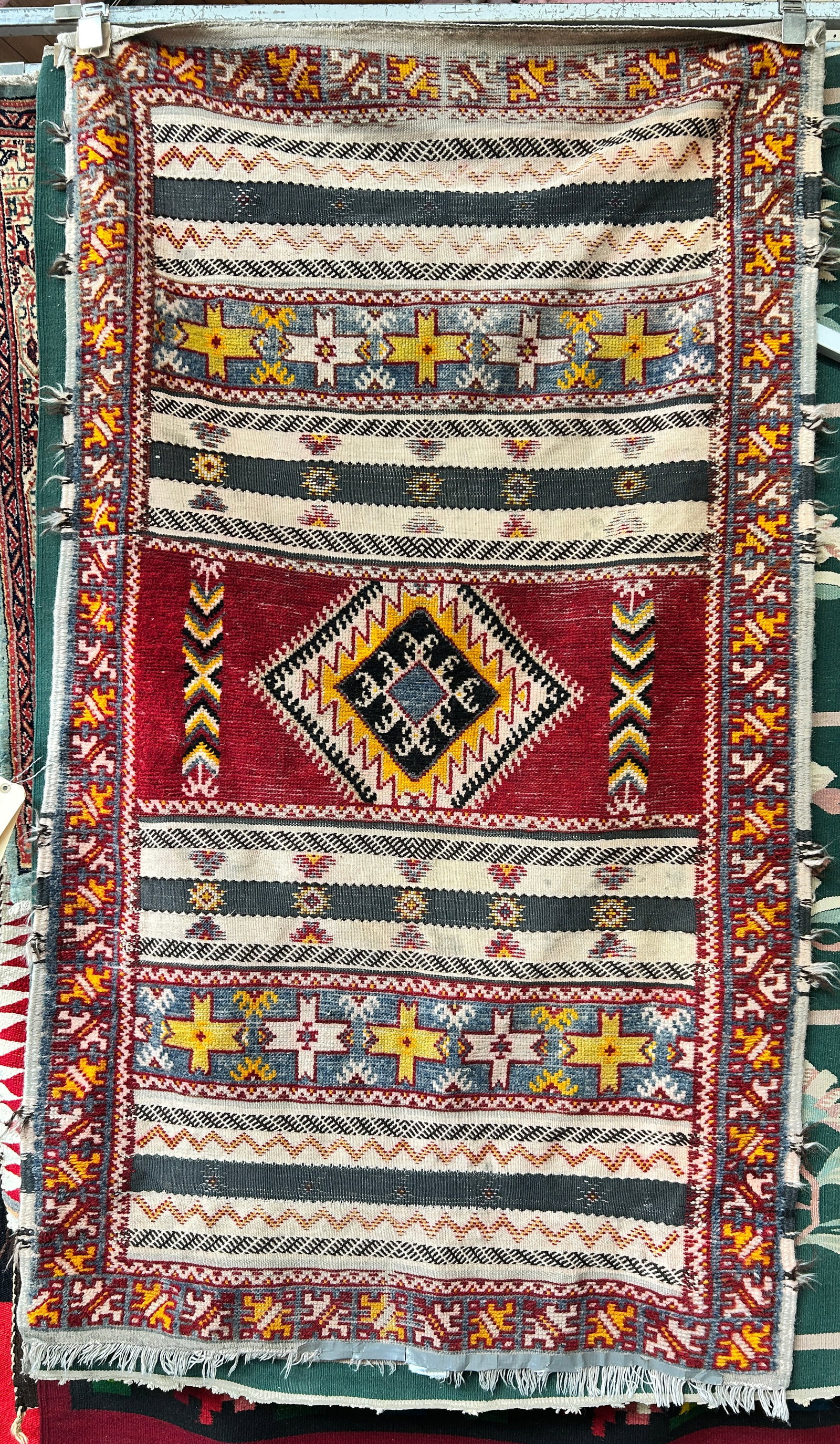 3' 5" x 6' Moroccan Style Wool Rug.: The rug has a few minor stains, but is in good overall condition. Some areas have a flat weave, while the majority of the rug has a plush weave. In-house shipping is available. To receive the best shi