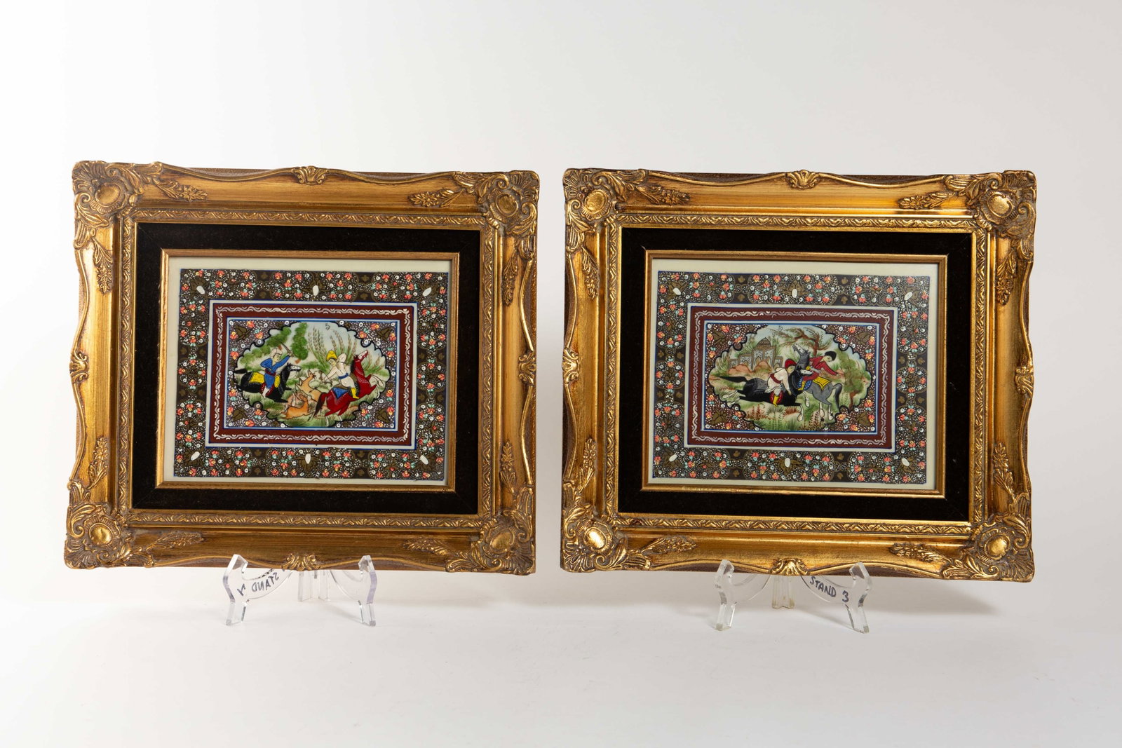 Two Persian Miniature Paintings in Gild Frames.: The lot contains 2 miniature painting with matching borders. One depicts a hunting scene, and the other features 2 people on horseback playing Polo, possibly a mother and son. The outer handpainted bo