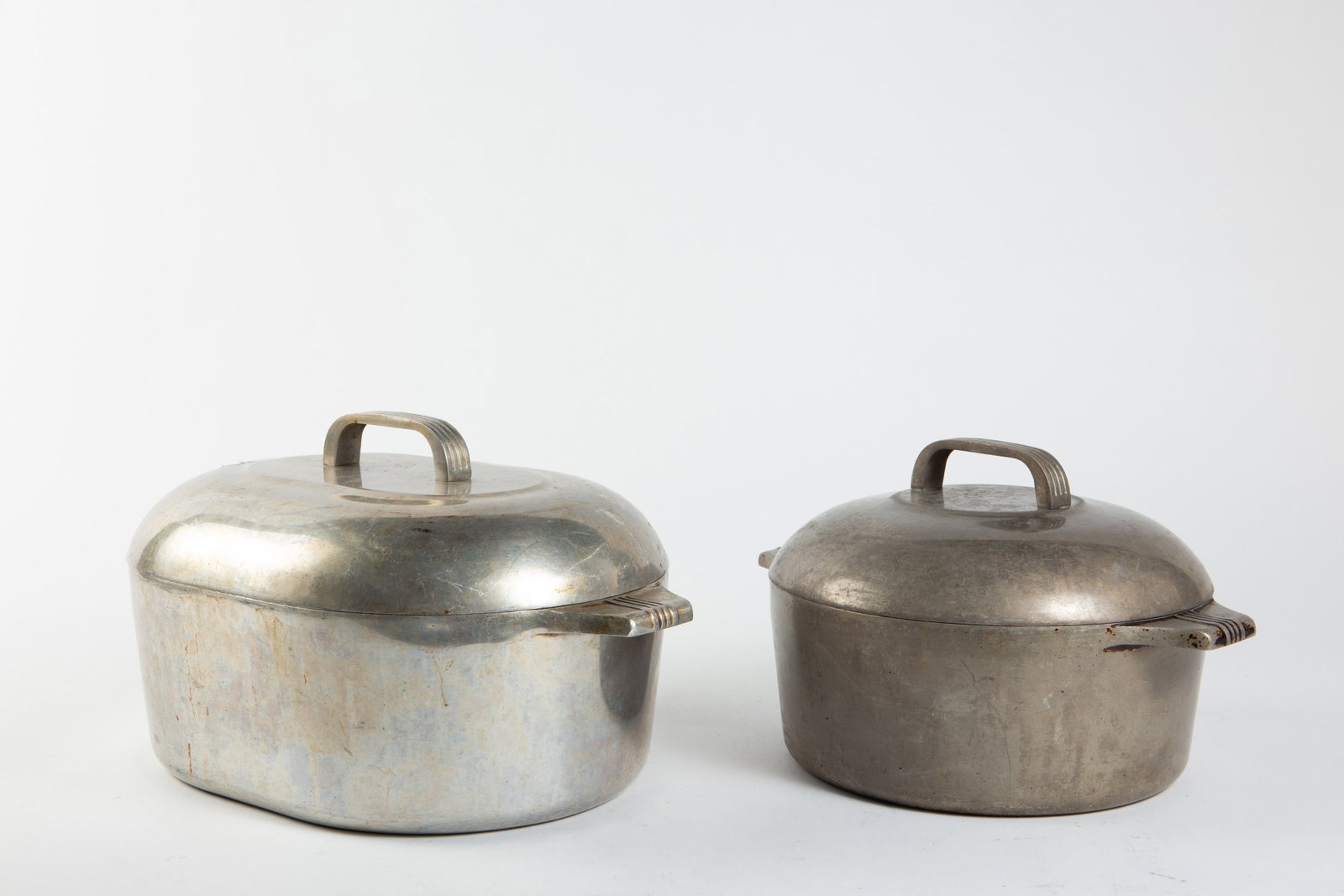 Wagner Ware Magnalite 4265-P & 4248-P.: These vintage aluminum pots have some signs of wear related to use and age, but still present well. The smaller pot measures 12 1/2" x 10 1/4" x 8" (lid included). The larger pot measures 10 1/8" x 15