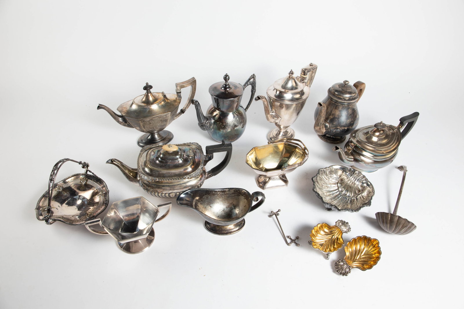 Lot of Assorted SIlverplate Serving Items.: This lot includes teapots, sugar bowls, and more. Most of the items look to be in good condition. The largest item measures 10" x 4 3/8" x 9". The smallest item measures 4 1/2" x 3" x 2". In-house shi