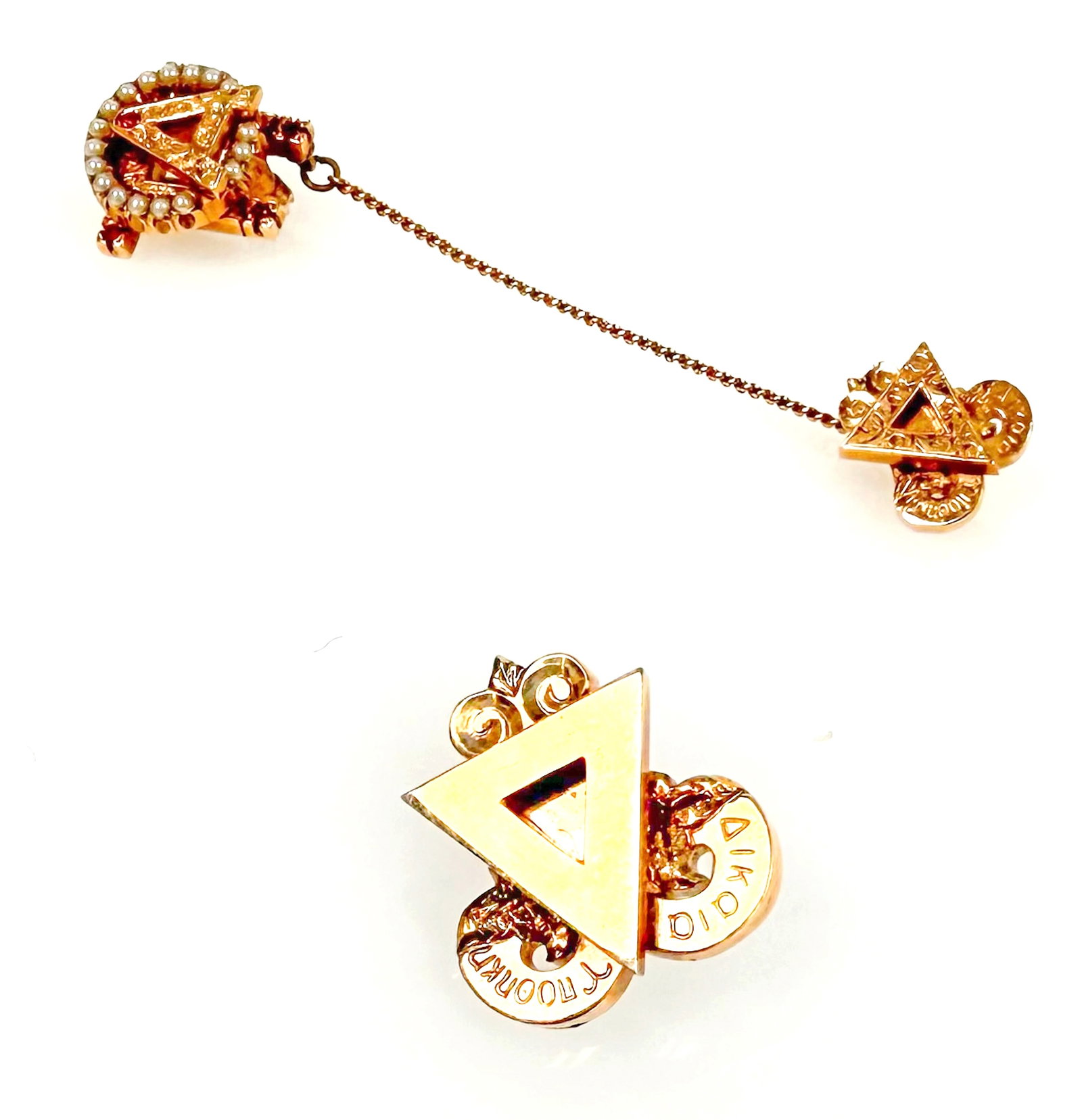 Lot: 10K Sorority & Fraternity Pins, Delta Upsilon: The lot contains 3 small brooches or pins, two of them connected by a non-gold chain. The largest pin is for Alpha Omicron Pi sorority, and features the letter A, 5 pink ruby stones, and a ring of see