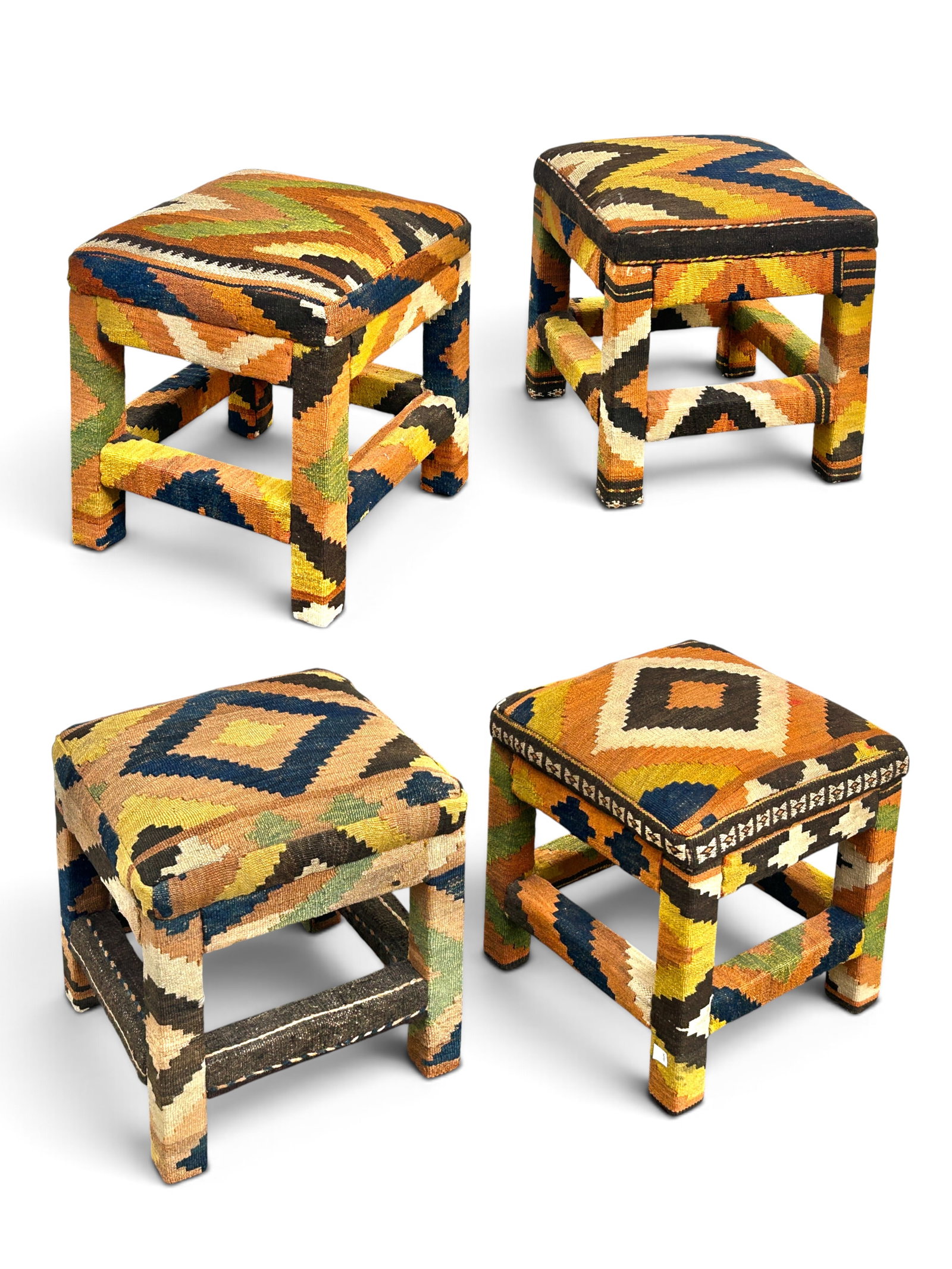 4 Kilim Upholstered Stools.: The lot consists of 4 matching square stools with stretchers and colorful geometric Kilem flatweave upholstery. Each stool measures 20 3/4" tall, 18" wide and 18" deep. The lot is in overall very good