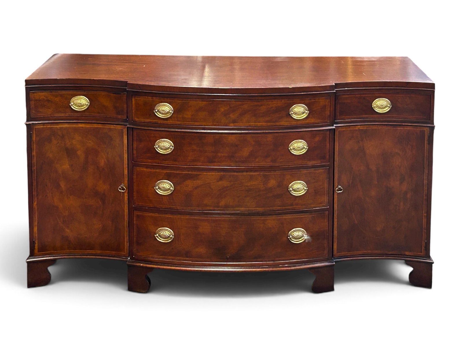 Baker Federal Style Burled Mahogany Buffet: The buffet or sideboard has a serpentine front, 6 drawers, brass hardware, and 2 doors with interior shelves. It measures 35" tall, 64" wide, and 20 1/2" deep. There are some indentations and