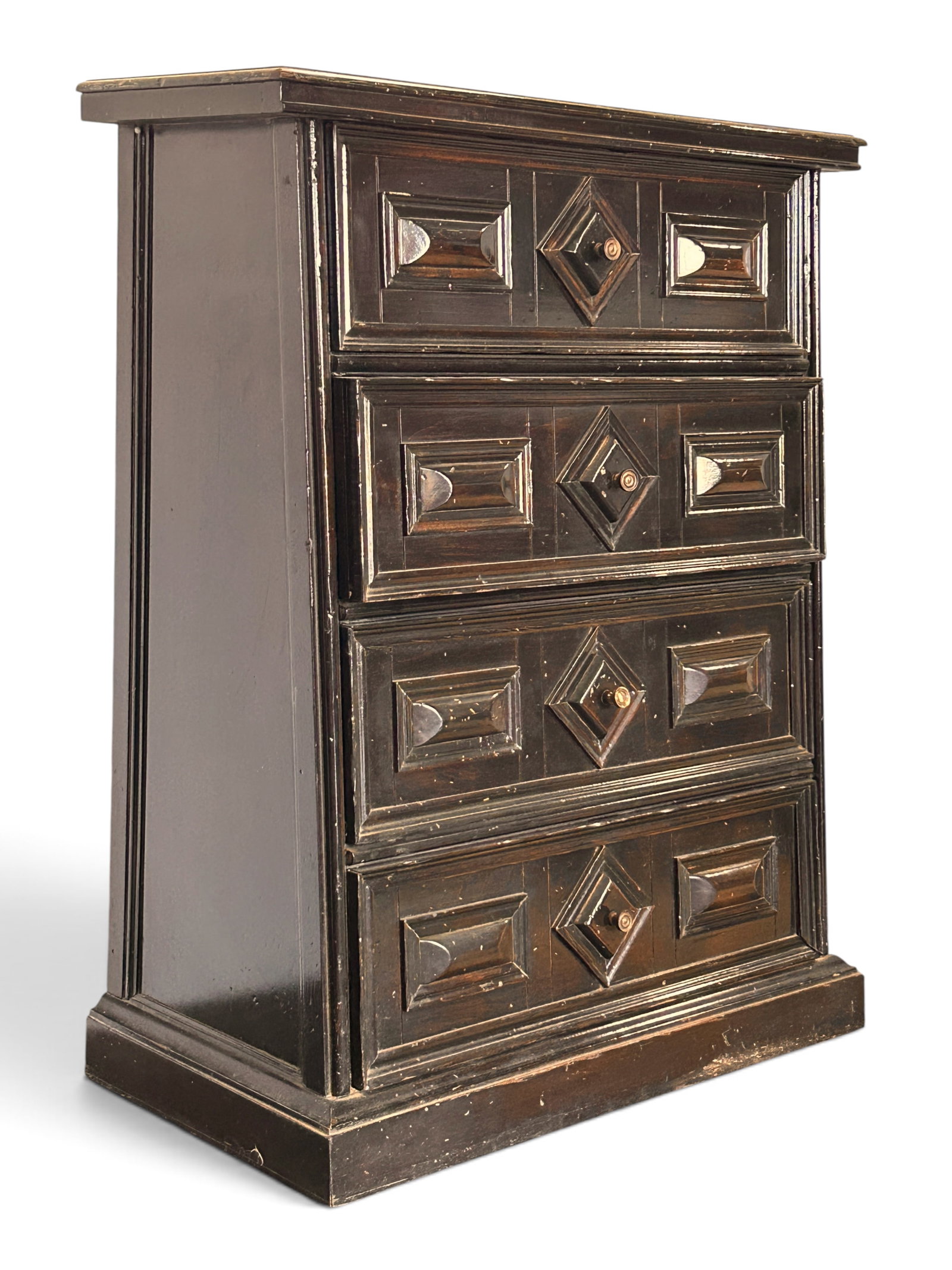 Antique Jacobean Carved 4-Drawer Chest.: The chest of drawers has a slightly angled front, with the bottom drawer being the deepest. The drawers feature geometric relief carvings and round brass knobs. It measures 34 1/4" tall, 28" wide, and