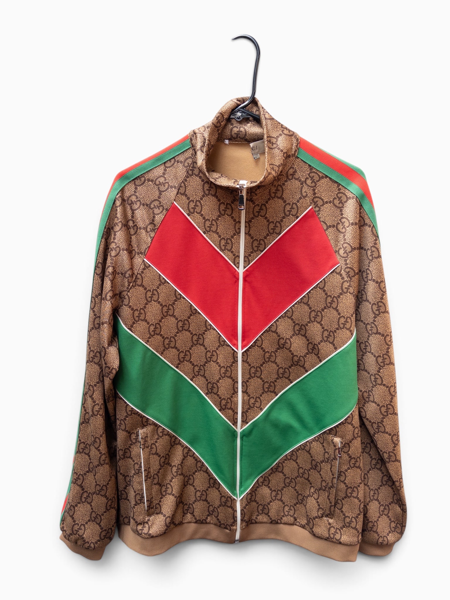 Gucci GG Brown Monogram Track Jacket, XXXL.: The jacket has a partially cut off neck tag. All of the zippers are branded appropriately, and the interior side tag is intact. The seemingly undersized jacket measures 22 1/2" from arm pit to arm pit
