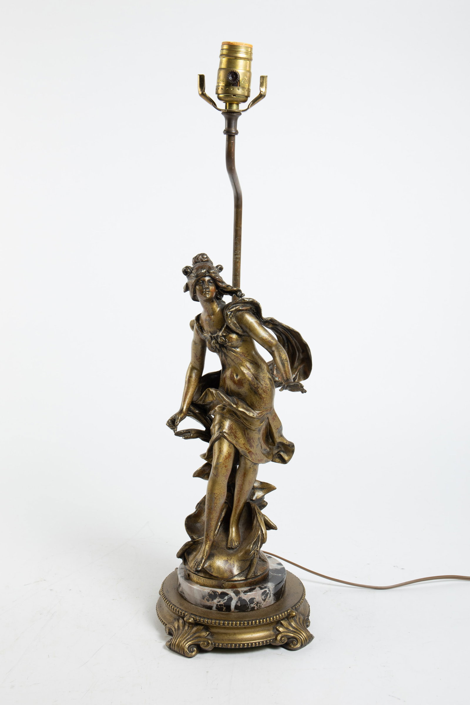 Aft. Auguste Moreau Gilt & Marble Figural Lamp.: The likely antique Art Nouveau style piece depicts a draped woman statuette on a black and white marble disk, which sit on a cast brass 4 legged base. The sculpture has a plaque which reads "Nymph de 