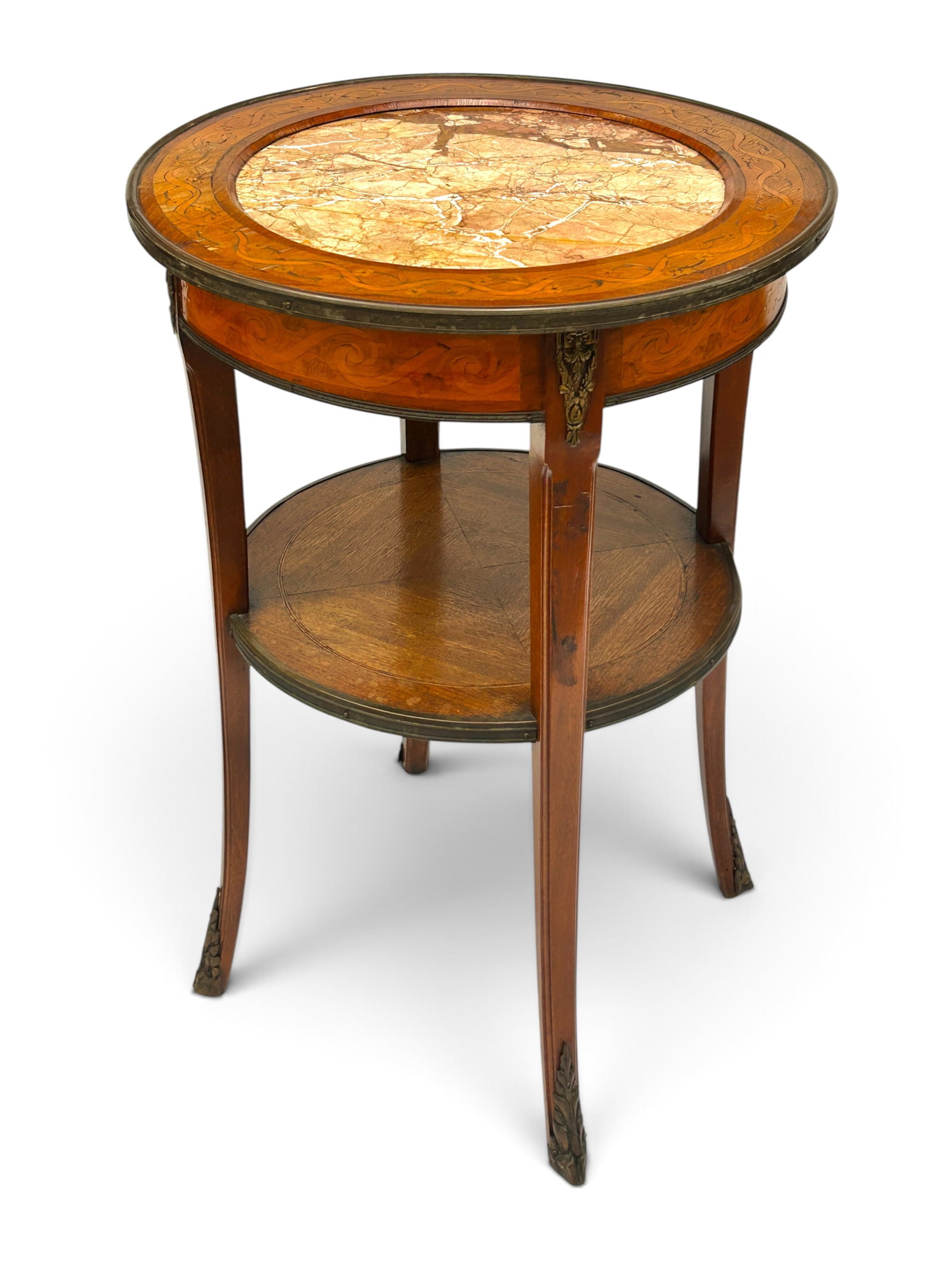 Antique Marquetry Marble & Glass Top Lamp Table.: The table has a round top with a recessed marble center, a wooden border with flower and ribbon marquetry decorations, an apron with with scroll and flower marquetry, and a glass top. The 4-legged