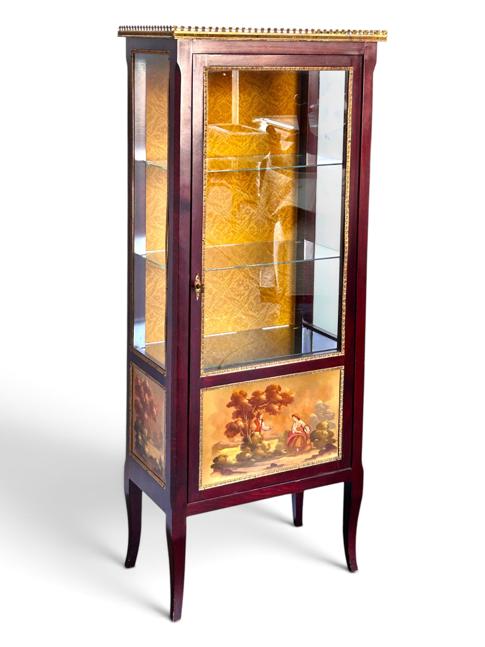 Louis XV Style Vitrine w/ Hand Painted Scenes.: The vintage showcase or curio cabinet has 3 glass sides with brass borders, a pierced brass gallery top, 3 glass shelves, a yellow textured fabric-wrapped back, a lock and key, and three handpainted p