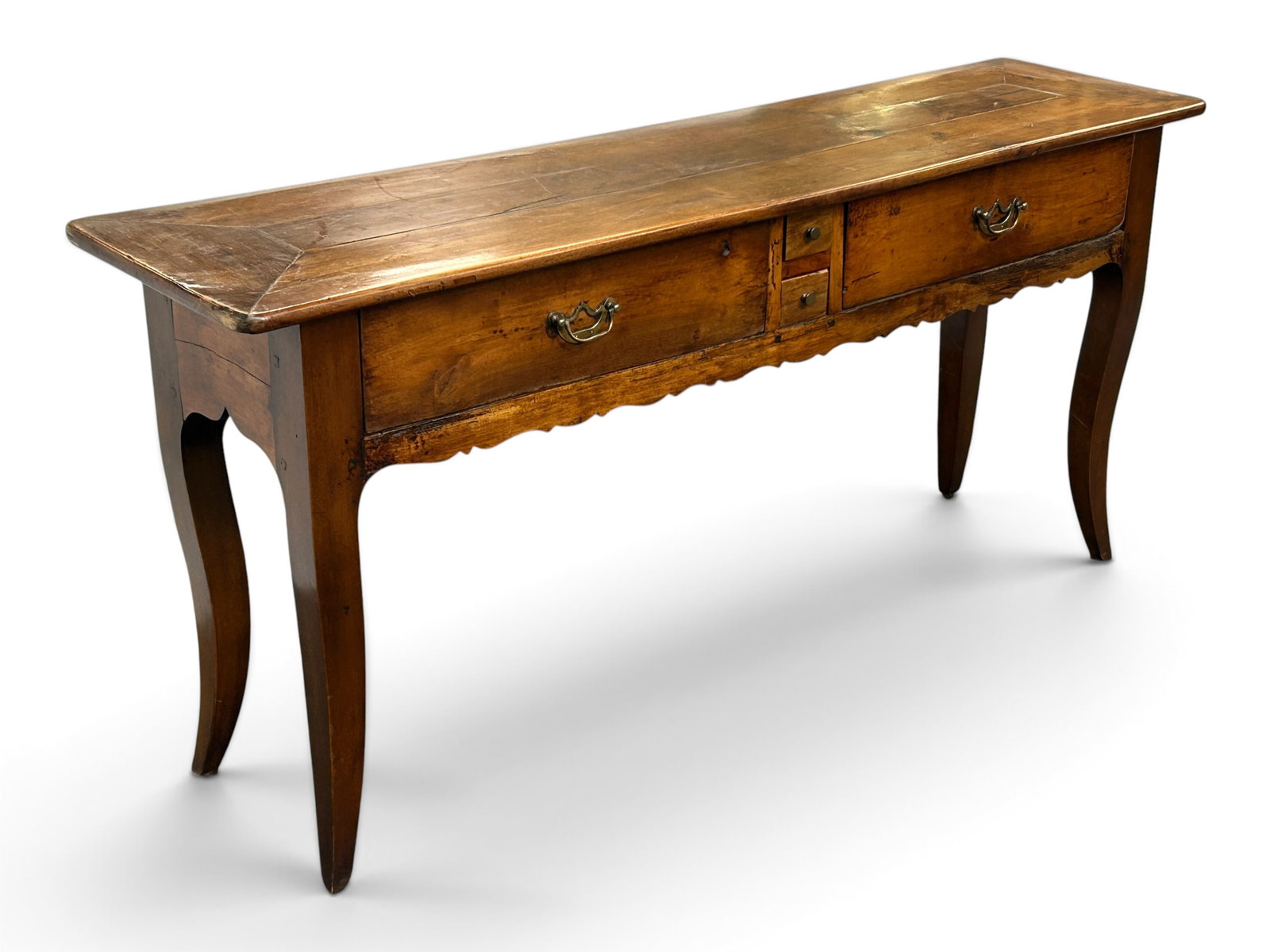 Antique Country French Hall Table or Server.: The piece features a plank style top, 2 small drawers flanked by 2 larger ones, brass hardware, a scalloped edge and apron, and curved legs. It measures 31" tall, 67" wide, and 17" deep. There are