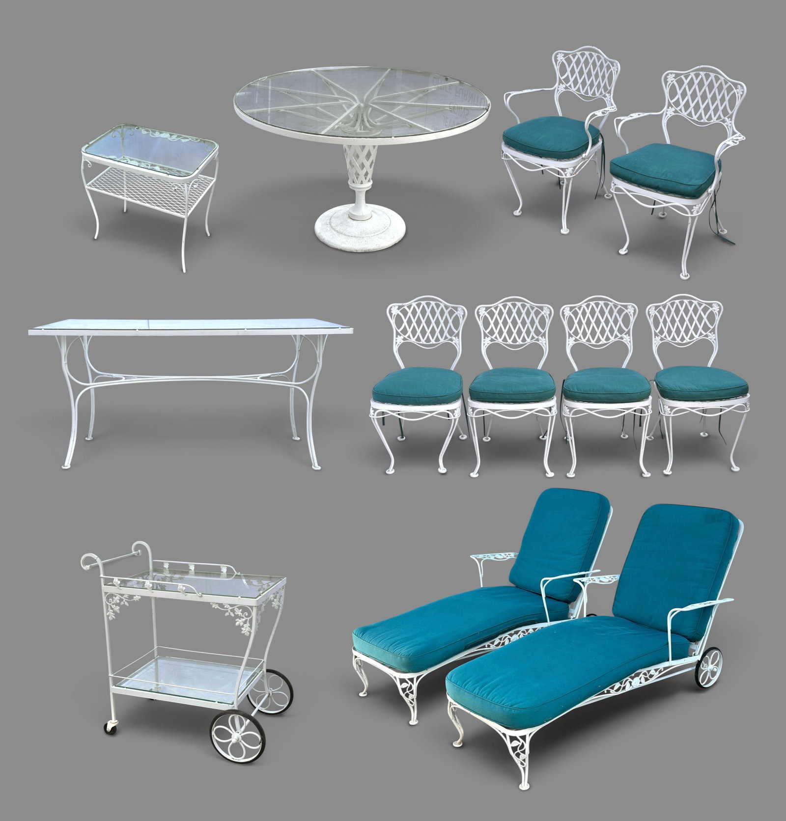 Lot Wrought Metal Outdoor Dining Set, Bar, & More.: The lot contains 12 pieces of furniture. There is a round glass top table, a rectangular glass top dining table, 4 side chairs, 2 arm chairs, two chaise lounges with back wheels, one 2-tier glass top 