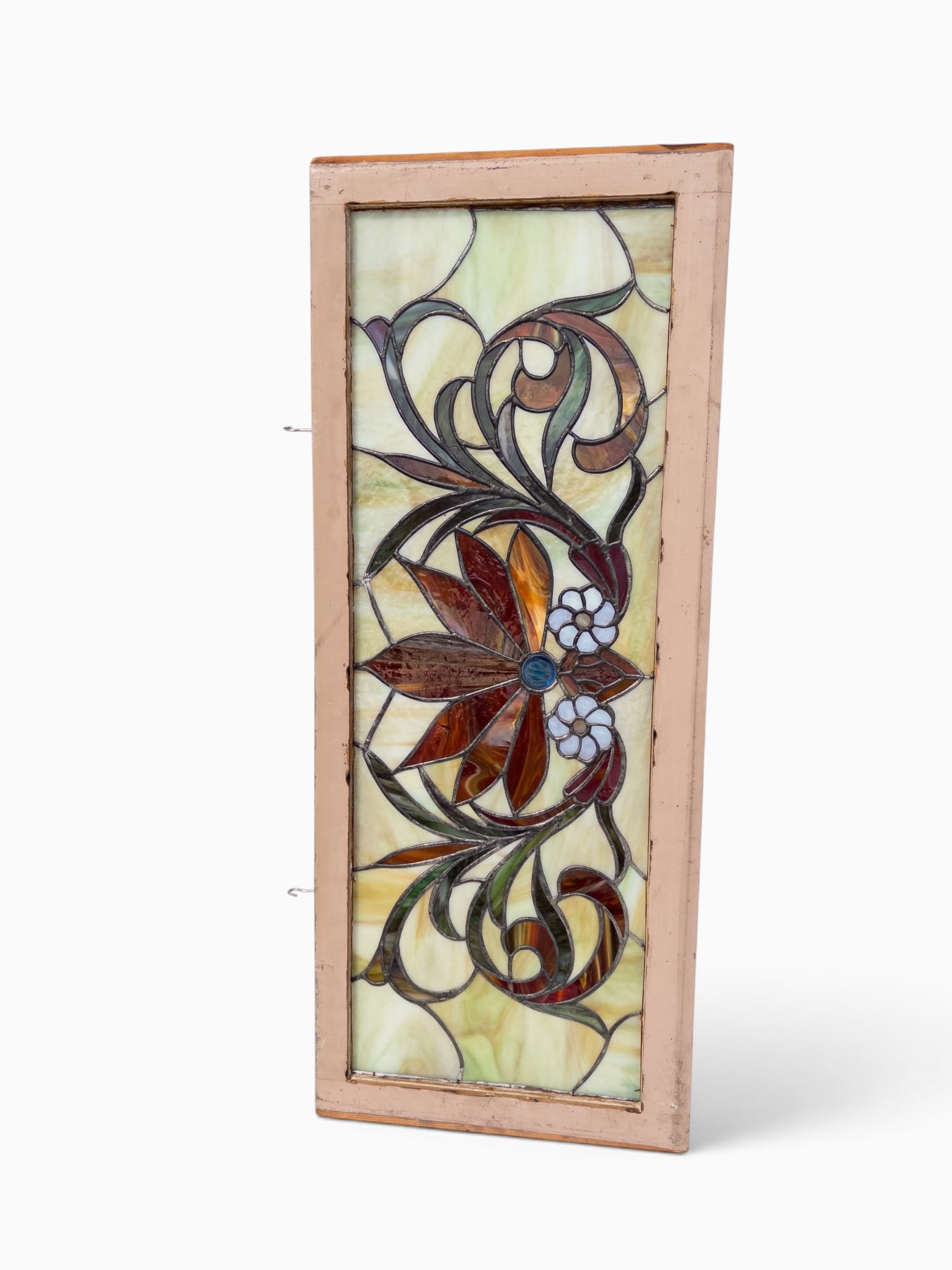Antique Art Nouveau Style Leaded Glass Window.: The transom window features a symmetrical design with a central cabochon jewel and two opalescent glass 7-petal flowers. The piece features textured and smooth slag glass. The light wood frame measure