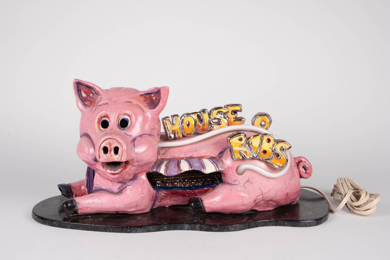 "House of Ribs" Pig Pottery Lamp w/ Neon Light.: The artist signature is a little difficult to make out; it may be Jon or Jan Butz. The attached base resembles a cutting or serving board, as if the pig is on a platter. There is a diner inside the