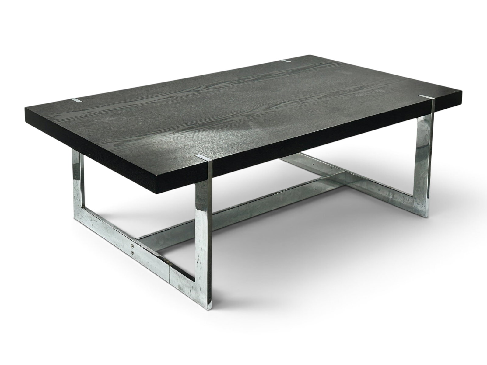 Contemporary Mid-Century Modern Style Coffee Table: The table has a dark purple wood veneer top and chrome trestle style legs. There are some small chips in the veneer, minor scratches, and a few stains. It measures 47" wide, 28" deep, and 16" tall.