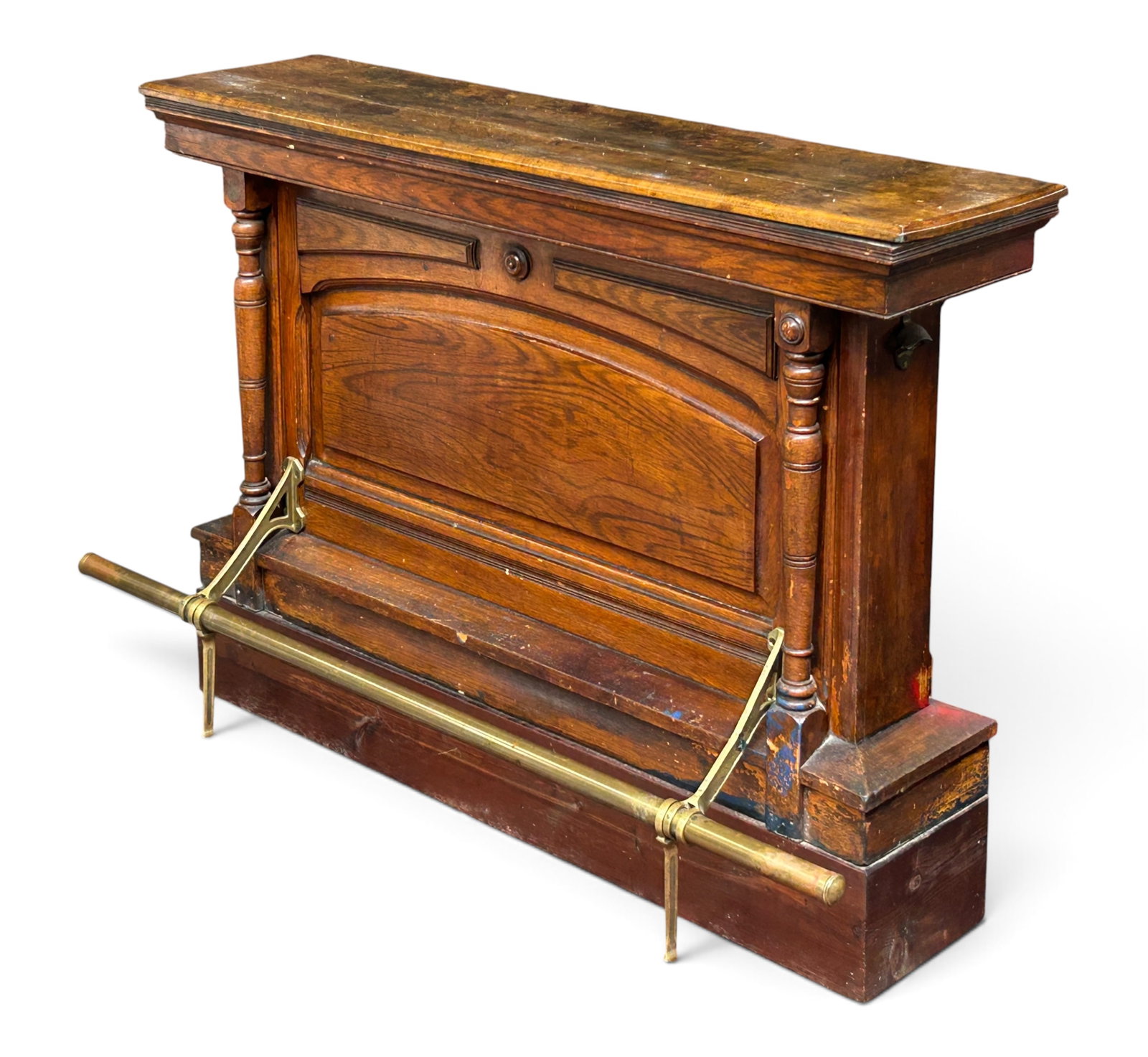 Antique Victorian Style Bar.: This bar or counter has columns, medallions, and a brass foot rest. The top is slightly warped, and is lighter in tone than the rest of the piece. One of the medallions is missing. There is a good