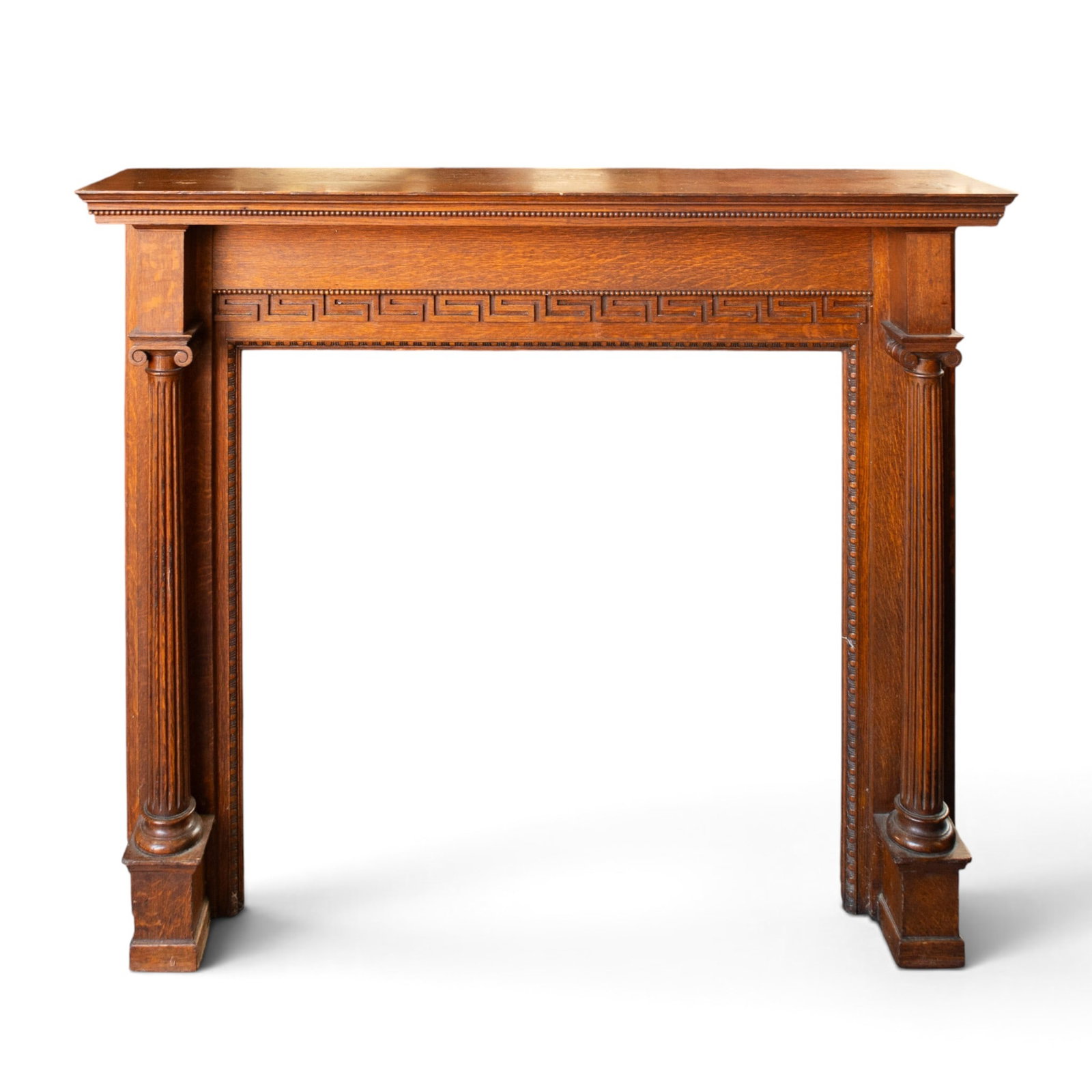 Antique Oak Fireplace Front.: The piece has fluted columns, a greek key design, and egg and dart molding around the central opening. There is some wear, but overall, the piece is in nice condition. It measures 60" wide, 12 1/2"