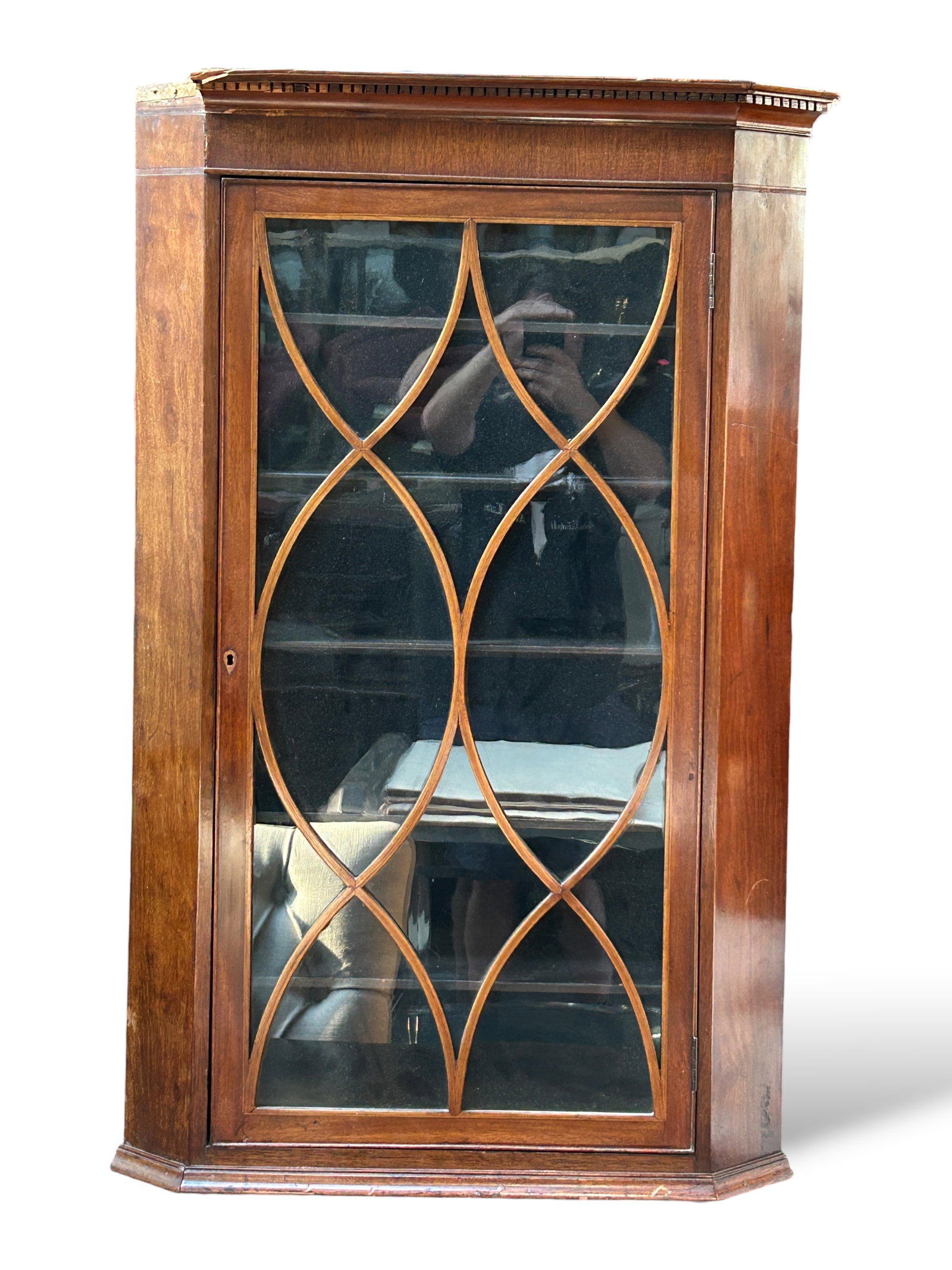 Antique Hanging Corner Cabinet, As Is.: This mahogany cabinet has a lockable glass-front fretwork door (key included) and five fixed shelves. The top has dentil molding, which is damaged on the left side. Otherwise the piece is in good cond