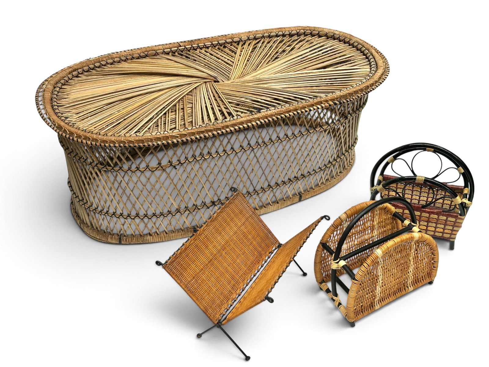 Wicker Coffee Table & Three Magazine Racks.: The vintage lot includes an oval wicker table, two basket-style magazine racks, and one V-shaped Mid-Century Modern metal and rattan rack. All four pieces seem to be in good condition, with minor wear
