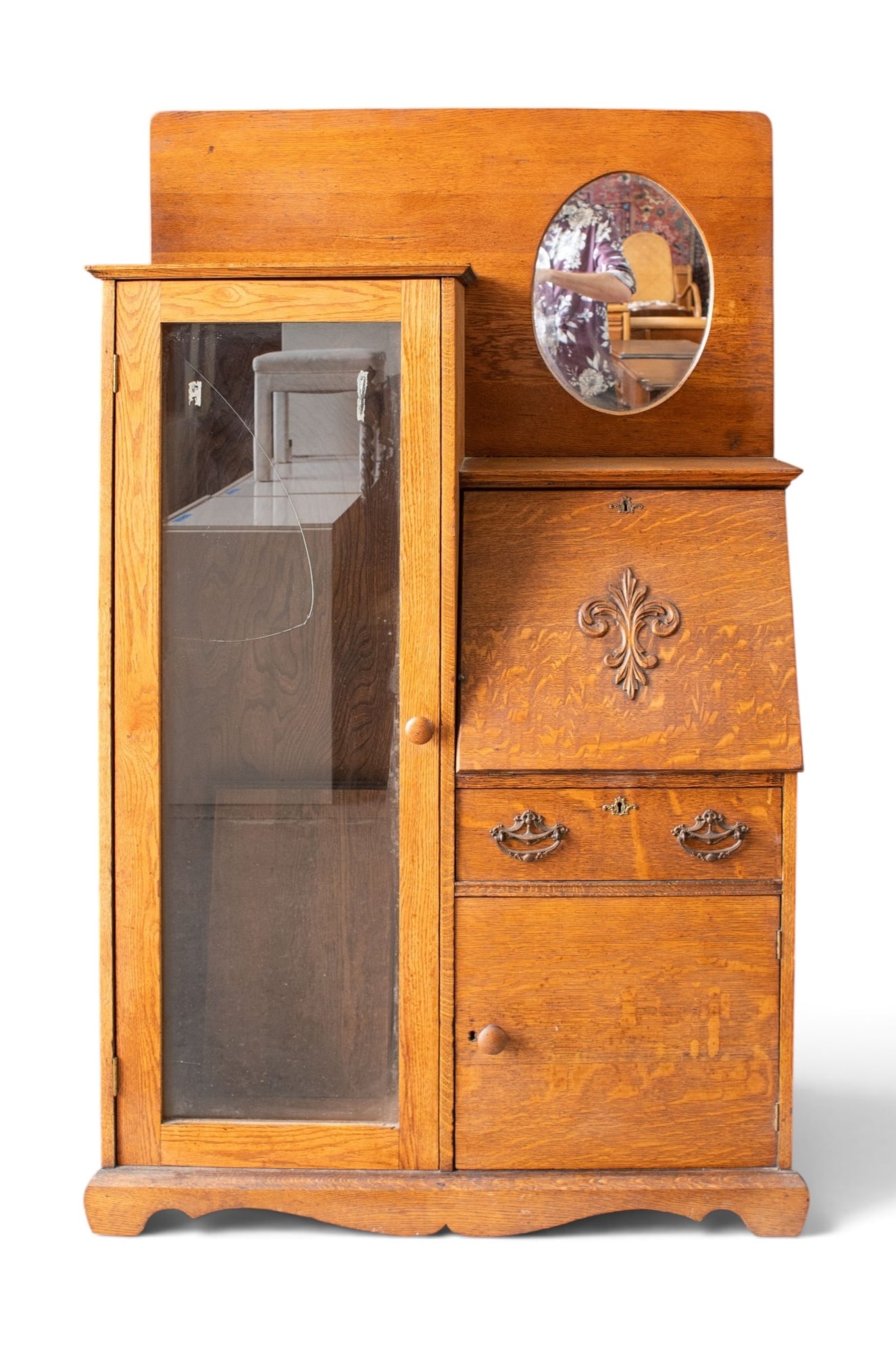 Antique Oak Side-By-Side Secretary Desk.: The left side of the piece has a glass-front display cabinet with three shelves. The shelves are included, but most of the pegs are missing. The glass door is cracked. The right side has a dropfront d