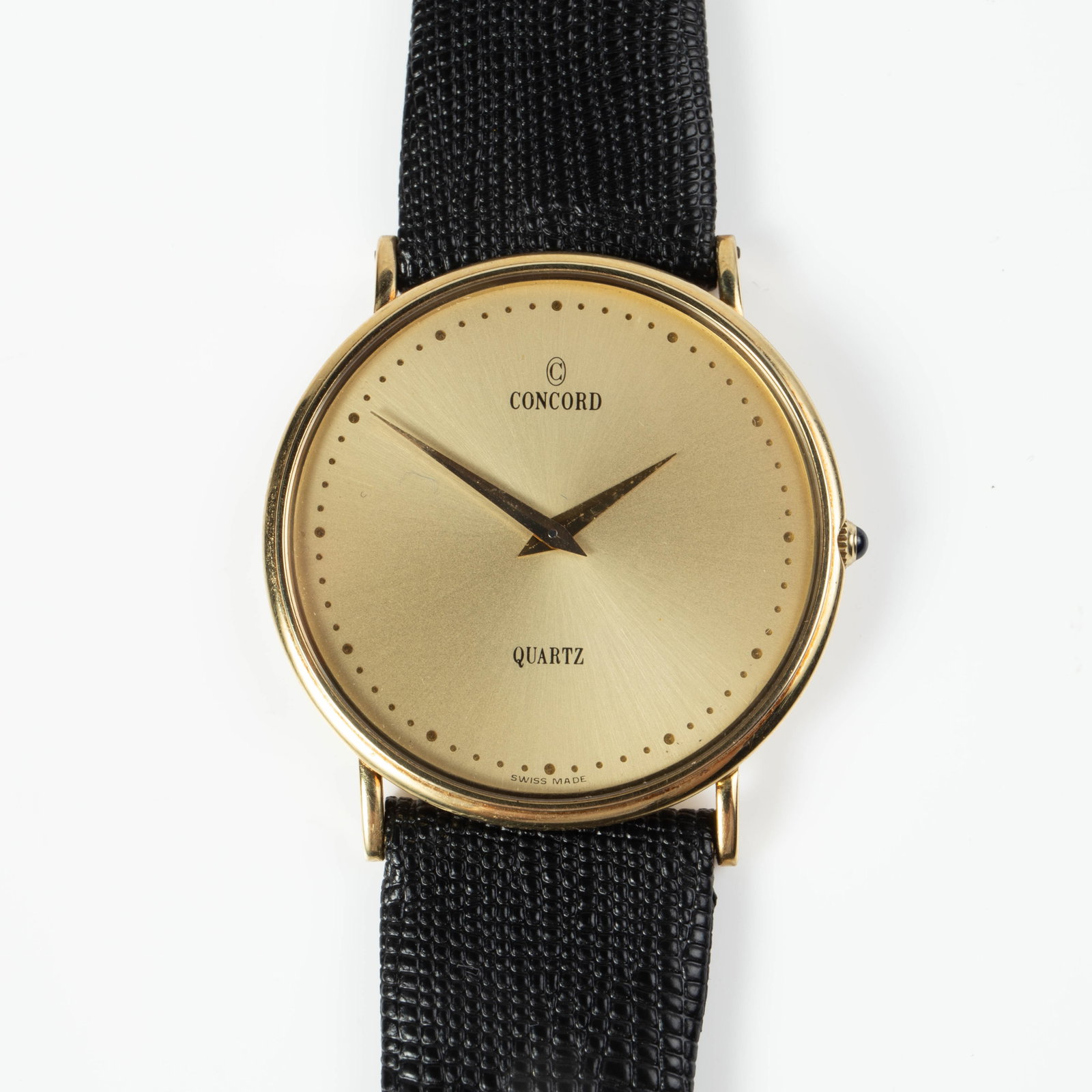 14K Gold Concord Ultra Thin Quartz Watch.: The watch is model #2081218 and serial #608129. It is marked 14K on the back of the case, along with the previously mentioned numbers. The case measures 32mm in diameter. The watch is not currently ti