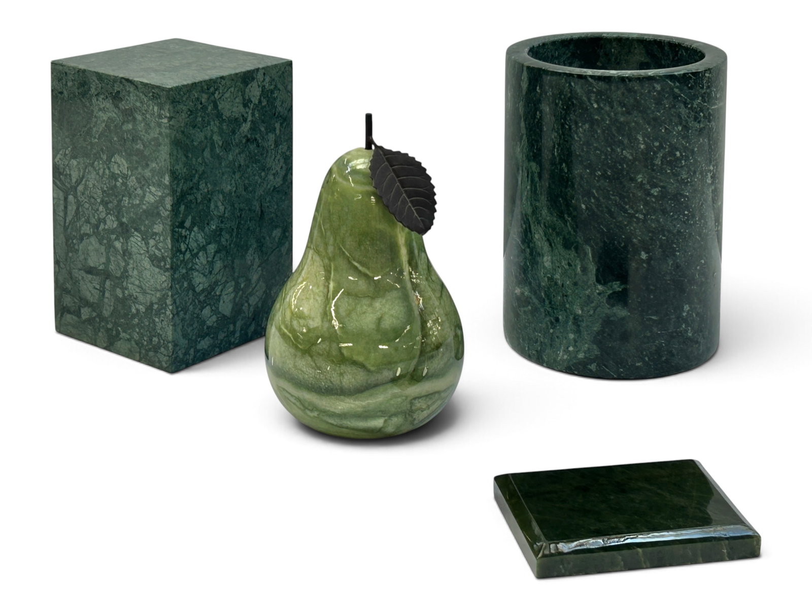 4 Green Marble, Alabaster, Jade Items - Pear, etc.: The lot contains 4 carved stone items. There are 2 green marble items: a solid rectangle stand and a cylindrical vessel or pot. Next, there is a large pear fruit figure with a metal stem and leaf,