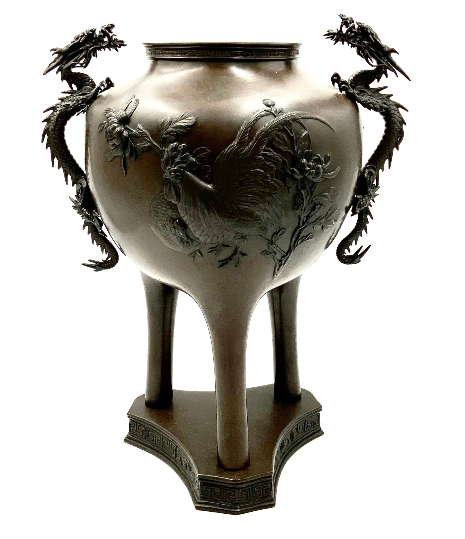 Japanese Meiji Period Bronze Tripod Vase.: The vase has handles in the shape of dragons, and rooster and chicken designs. It is signed on the Base. It measures 17 1/2" Tall and 14" Wide (From Handle End to Handle End). In-house shipping is ava